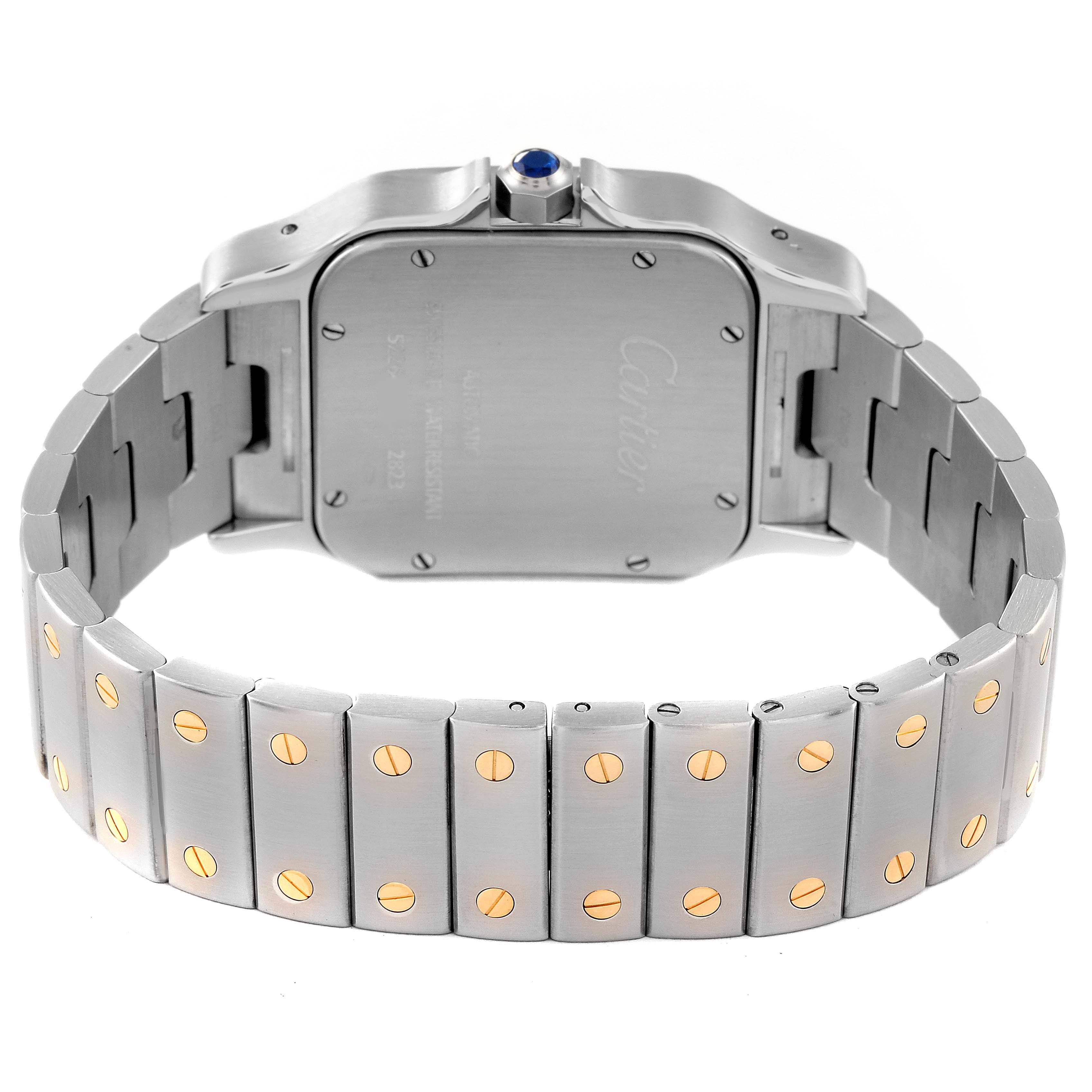 The image shows the back view of the Santos model by Cartier, highlighting the case, bracelet, and the crown with a blue gem.