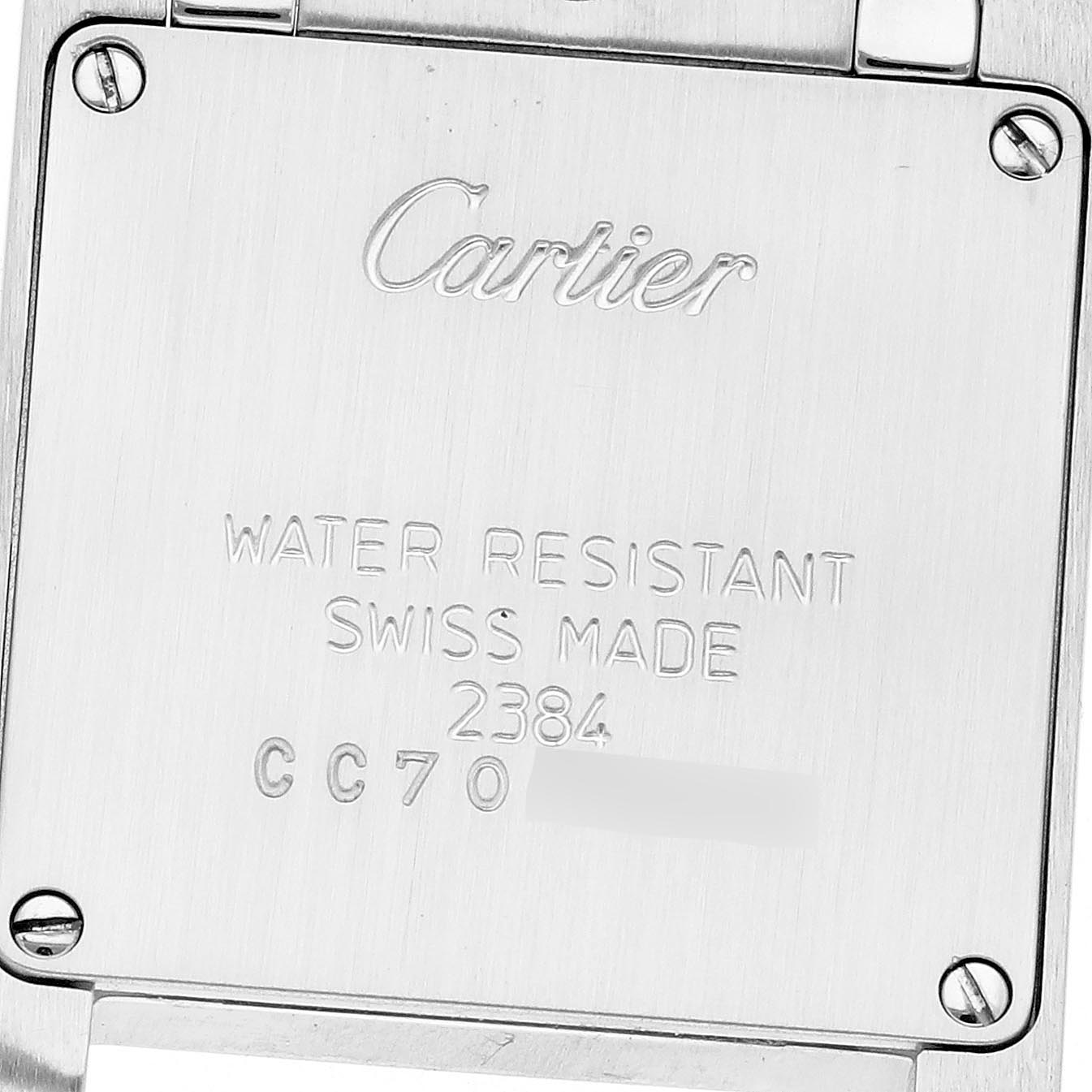 The image shows the back of a Cartier Tank Française watch, displaying engravings and four screws.
