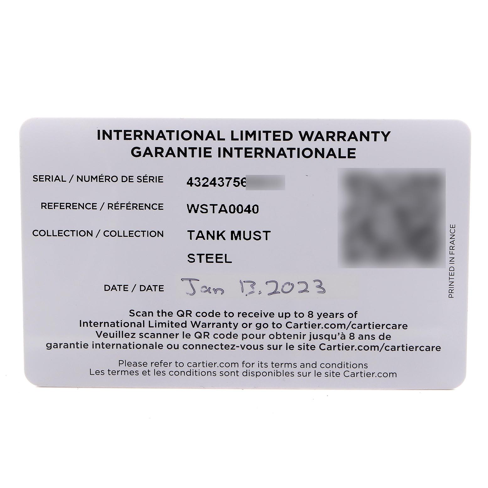 The image shows an international warranty card for the Cartier Tank Must WSTA0040 Men's Stainless Steel Silver Dial WSTA0040 Men's Stainless Steel Silver Dial model, viewed from above.