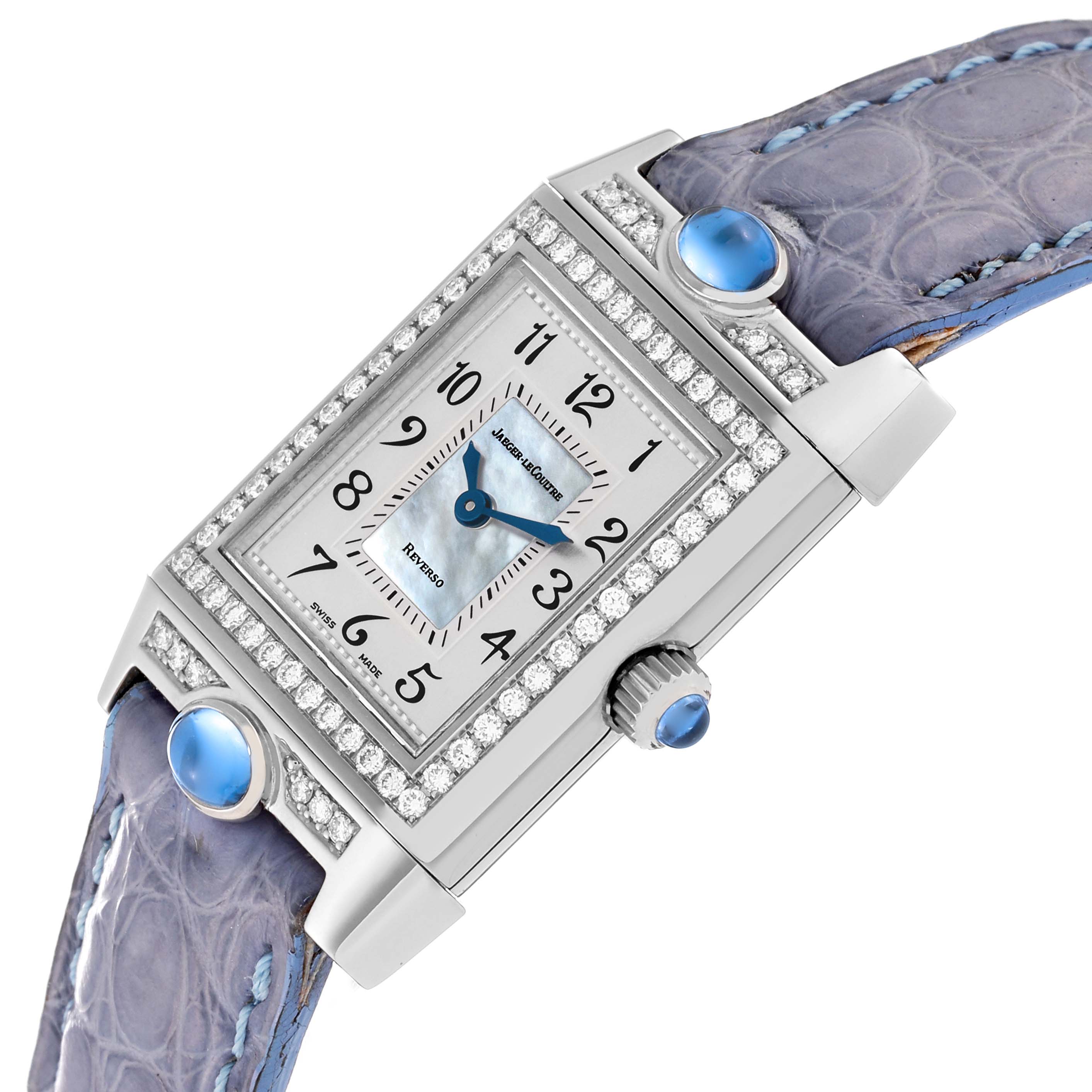 The image features a Jaeger LeCoultre Reverso Q2623403 Women's White Gold Mother of Pearl Dial Q2623403 Women's White Gold Mother of Pearl Dial watch, showing the face, crown, and decorated strap at an angle.