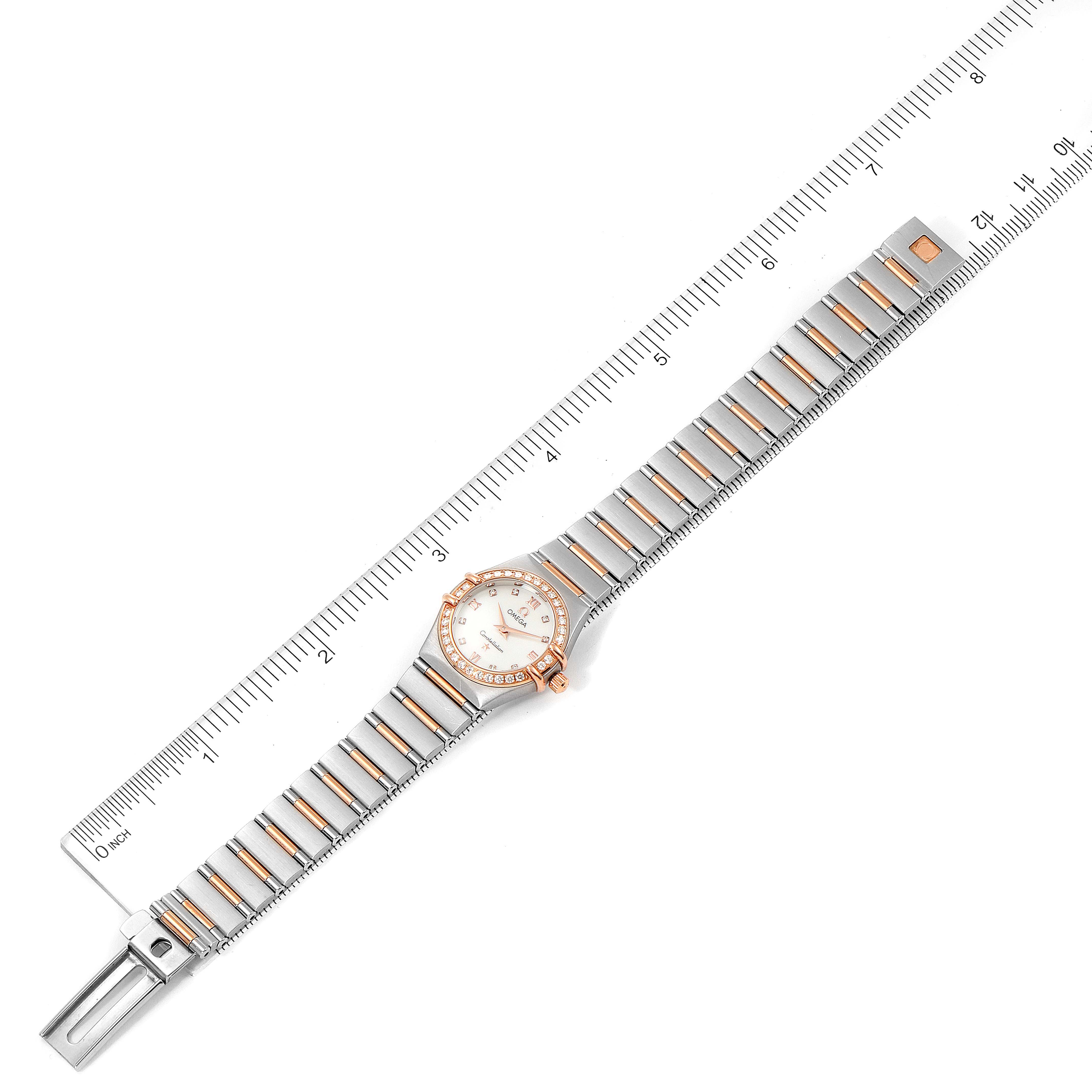The image shows an Omega 1360.76.00 Women's Steel and Gold (two tone) Mother of Pearl Dial 1360.76.00 Women's Steel and Gold (two tone) Mother of Pearl Dial Constellation Mini Steel Rose Gold Diamond Watch 1360.76.00 laid flat next to a ruler.