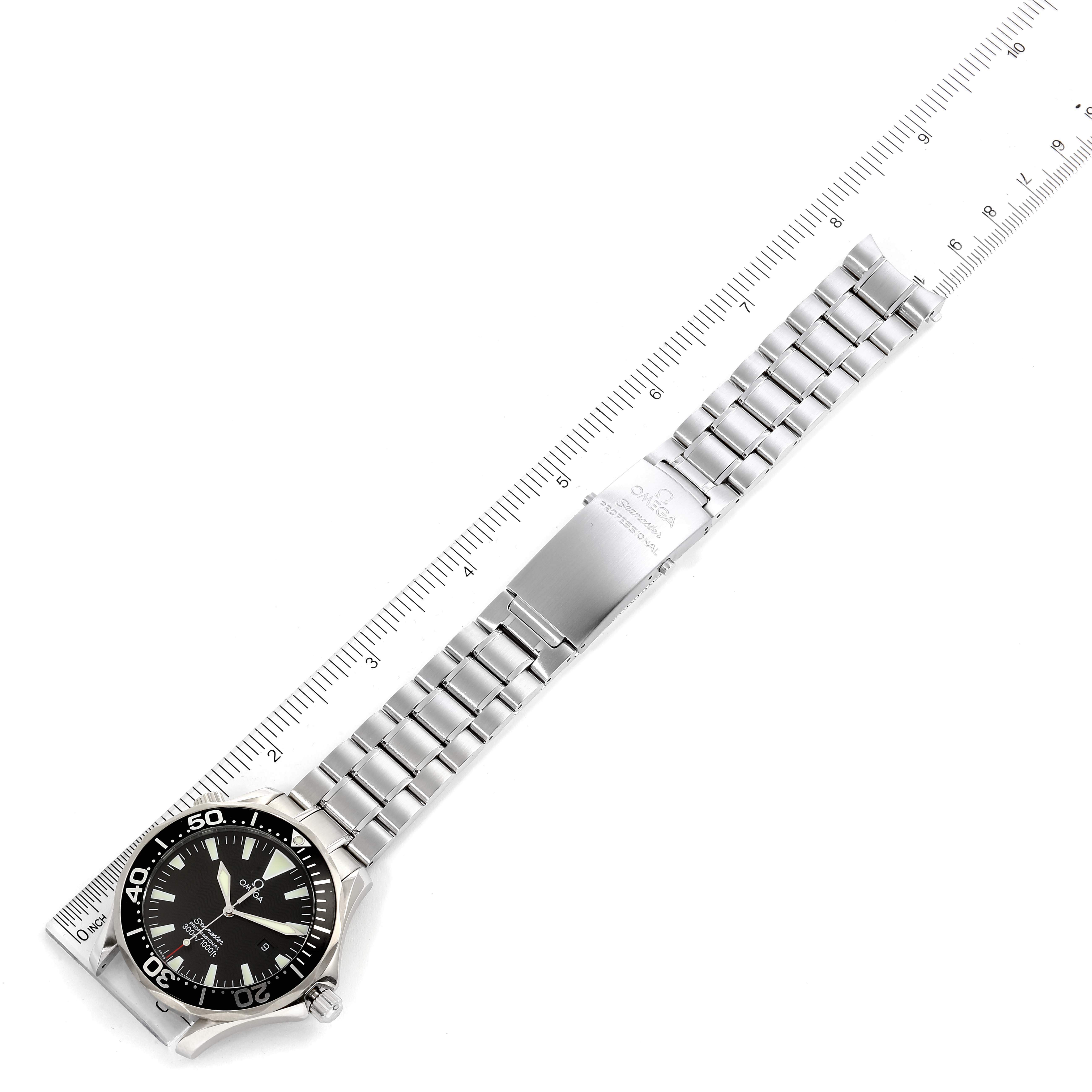 The image shows an Omega Seamaster 2264.50.00 Men
s Stainless Steel Black Dial 2264.50.00 Men
s Stainless Steel Black Dial watch laid flat, highlighting its face, band, and clasp, with a ruler for measurement reference.