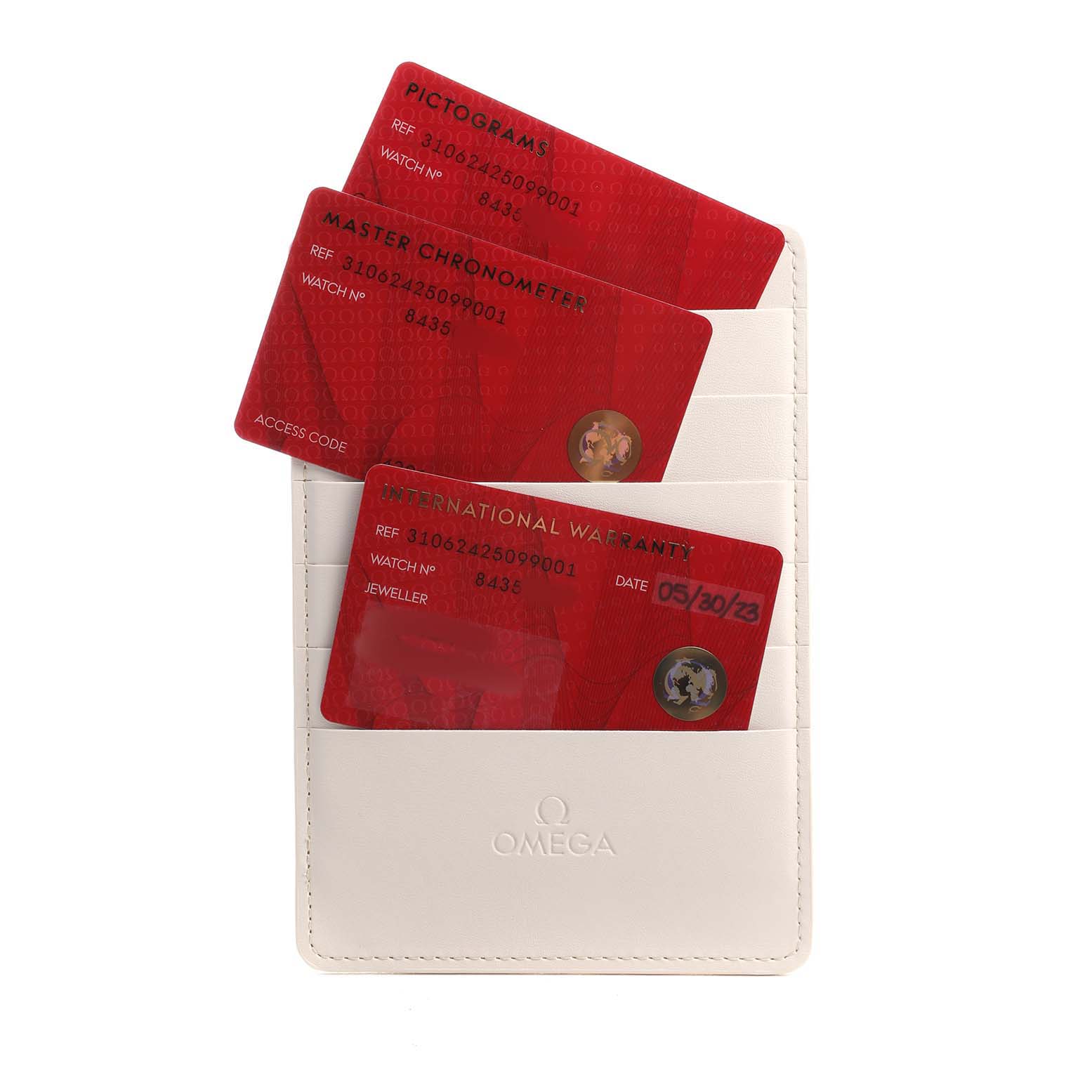 The image shows a white Omega cardholder with red cards for the Speedmaster model, including warranty and certification cards.