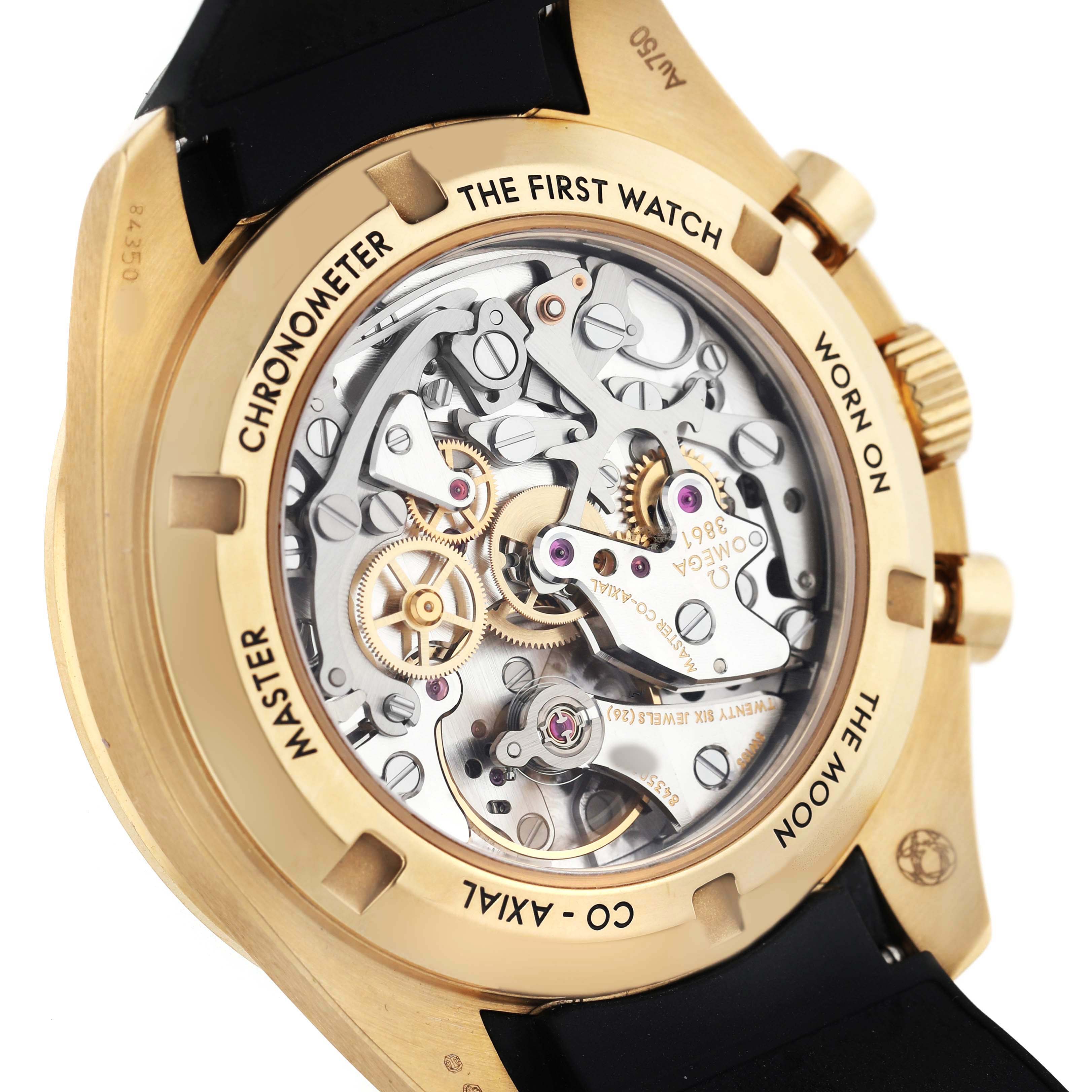 The image shows the case back of the Omega Speedmaster 310.62.42.50.99.001 Men's Yellow Gold Yellow Dial, highlighting its intricate movement and "The First Watch Worn on the Moon" engraving.