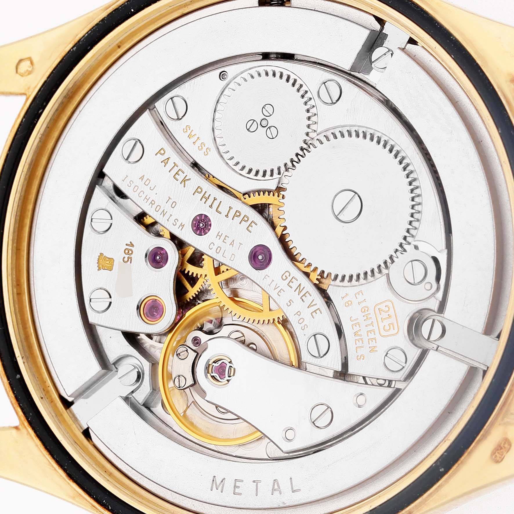 The image shows the back view of a Patek Philippe Calatrava 5023 5023J Men's Yellow Gold Silver Dial, revealing its intricate mechanical movement.
