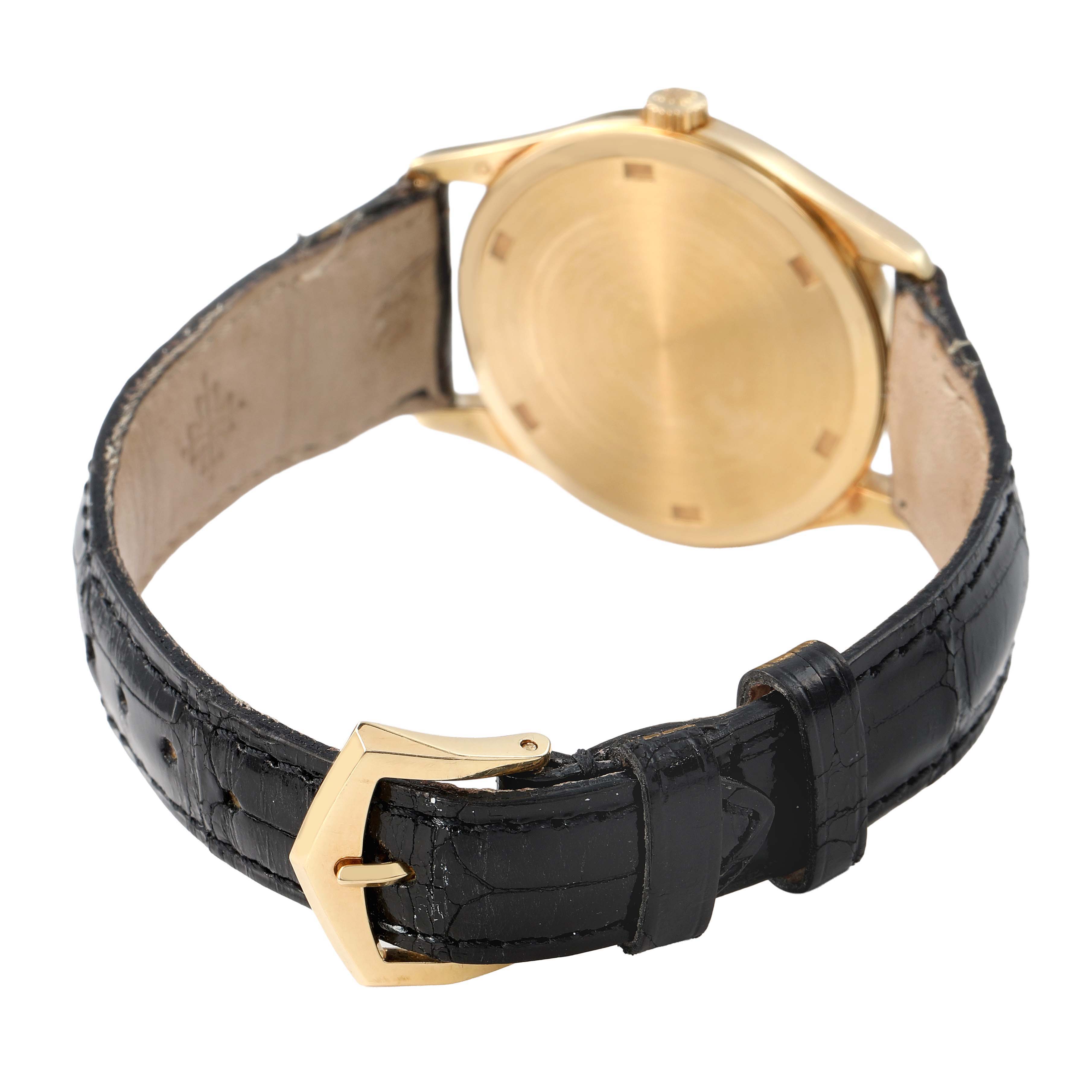 The Patek Philippe Calatrava 5023 5023J Men's Yellow Gold Silver Dial watch is shown from the back, highlighting the case, leather strap, and buckle.