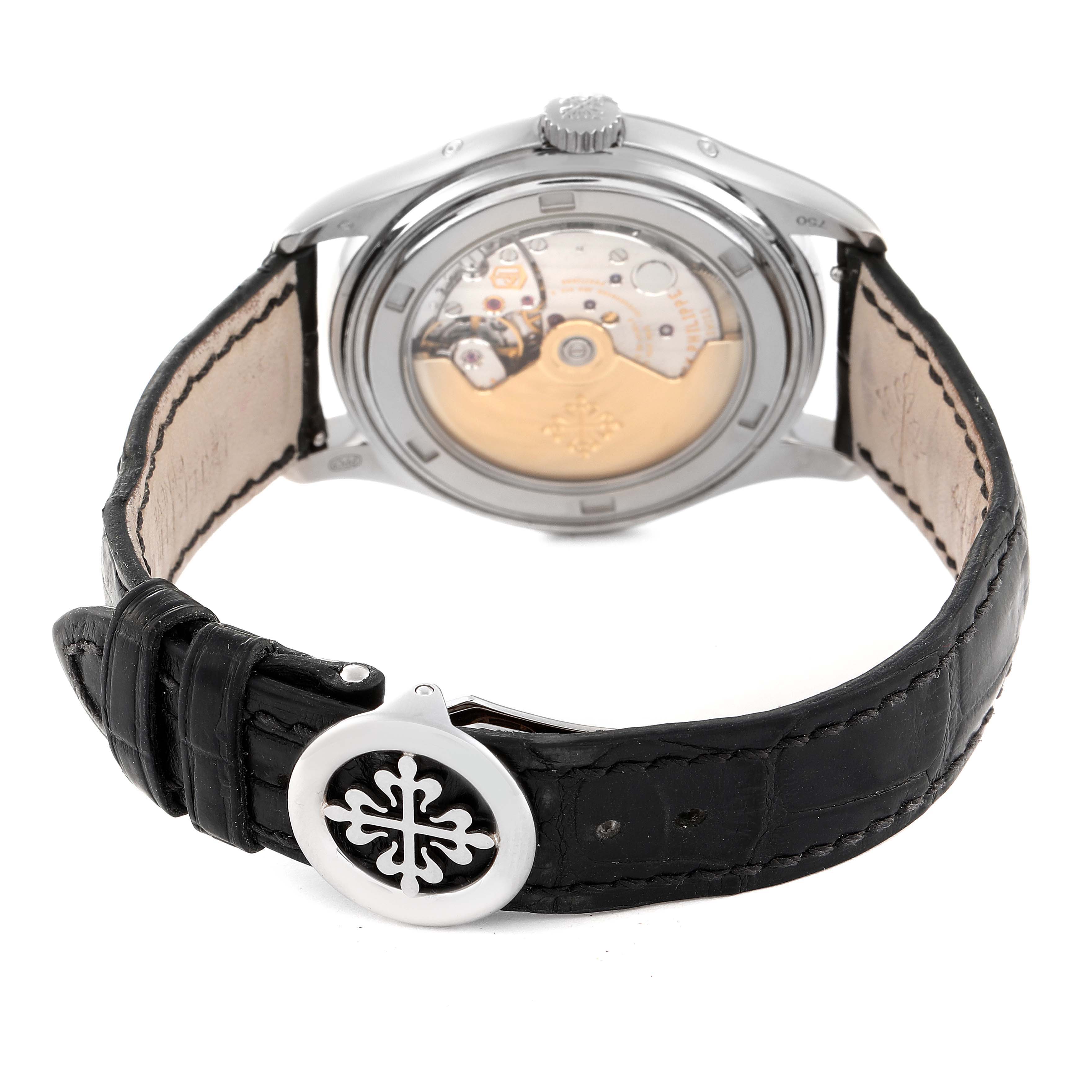 The image shows the back view of a Patek Philippe Complications 5146G Men's White Gold Beige Dial 5146G Men's White Gold Beige Dial watch, highlighting the movement and leather strap with the clasp.