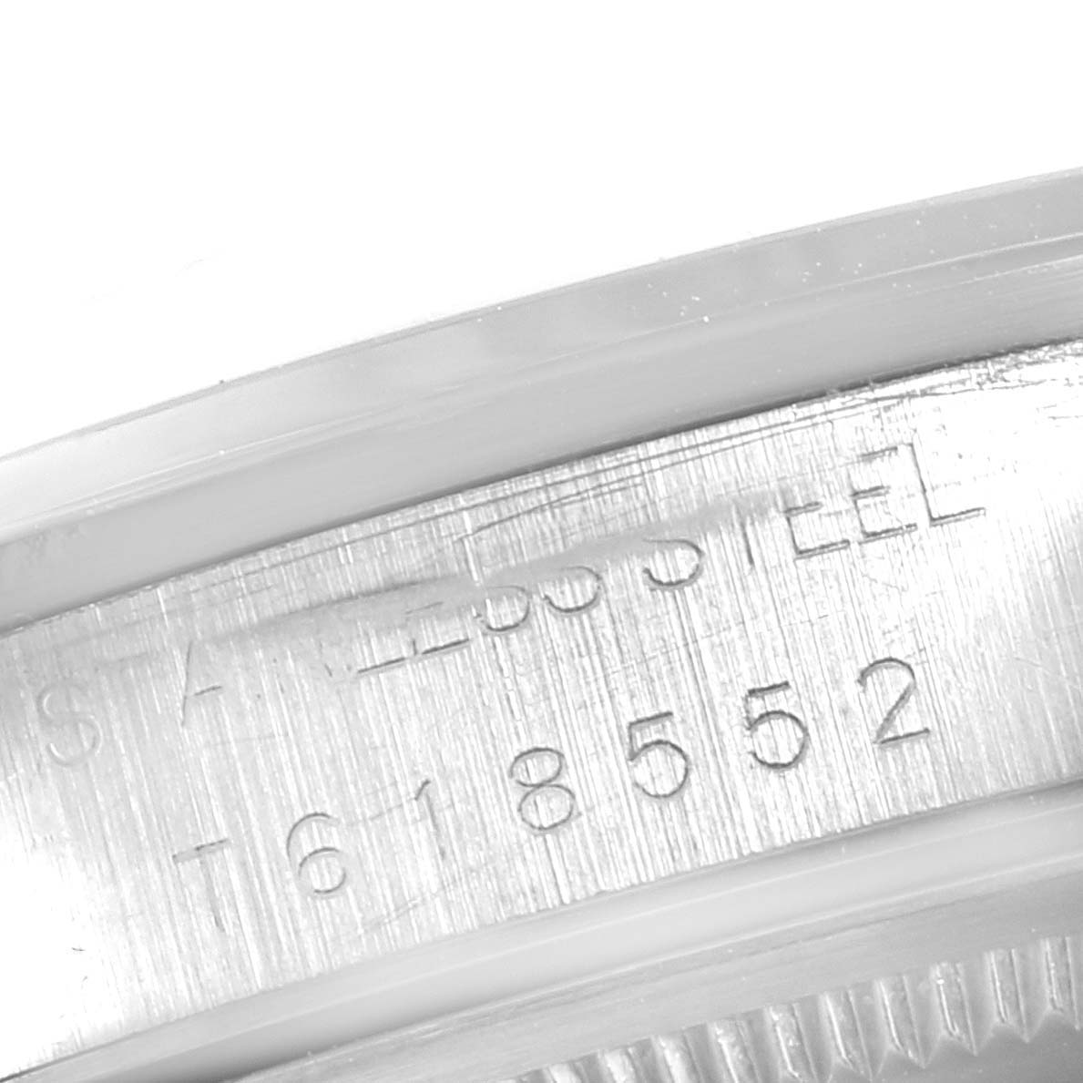 This close-up image shows the engraved serial number and "STAINLESS STEEL" markings on the case of the Rolex Air-King 14000 Men's Stainless Steel Black Dial 14000 Men's Stainless Steel Black Dial watch.