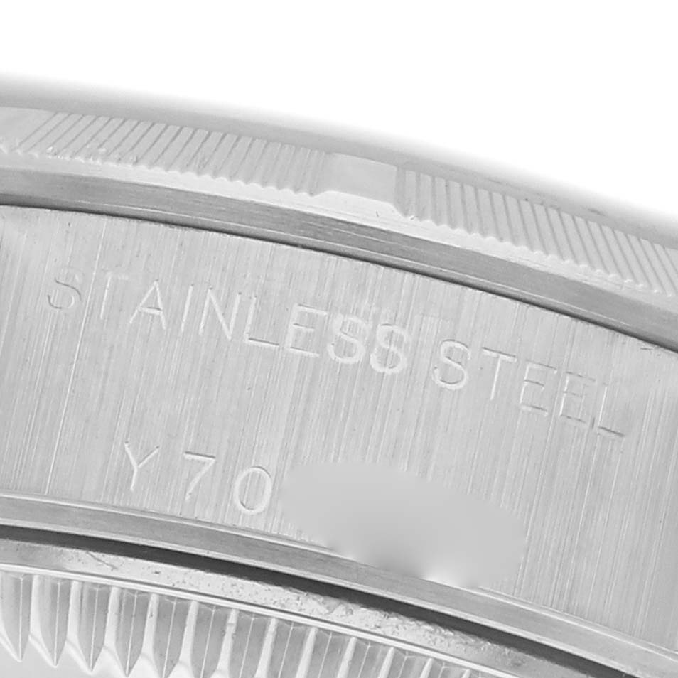 The image shows an angled close-up of the stainless steel case back of a Rolex Date 79190 Women's Stainless Steel Black Dial 79190 Women's Stainless Steel Black Dial model.