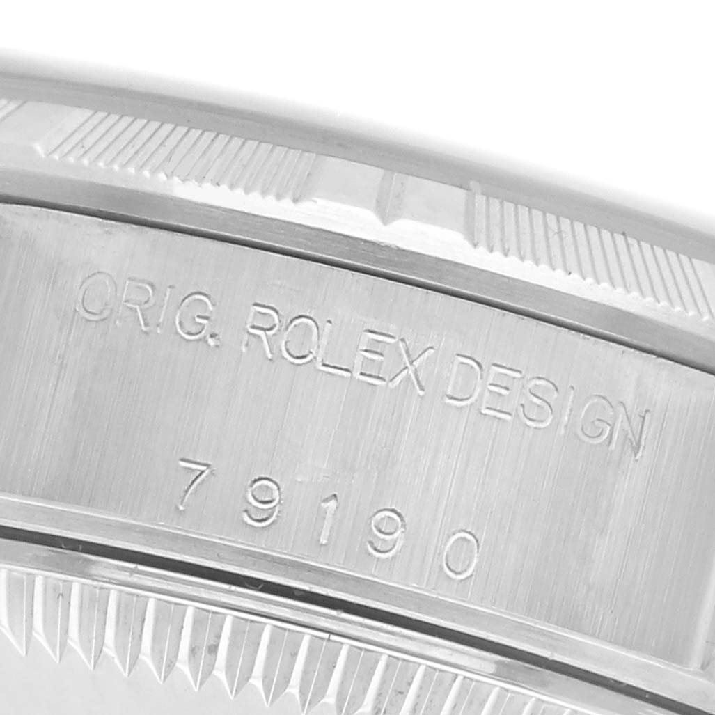 The image shows a close-up of the side engraving on the bezel of a Rolex Date 79190 Women's Stainless Steel Black Dial 79190 Women's Stainless Steel Black Dial watch.