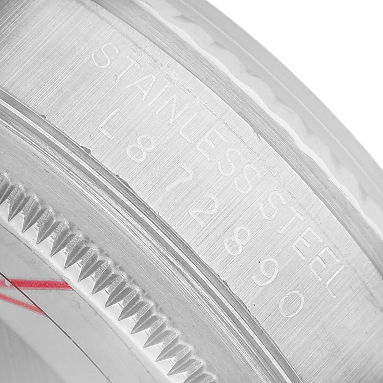 The image shows a close-up of the stainless steel serrated bezel and engravings on a Rolex Datejust 16234 Men's Steel and Gold (two tone) Silver Dial model.