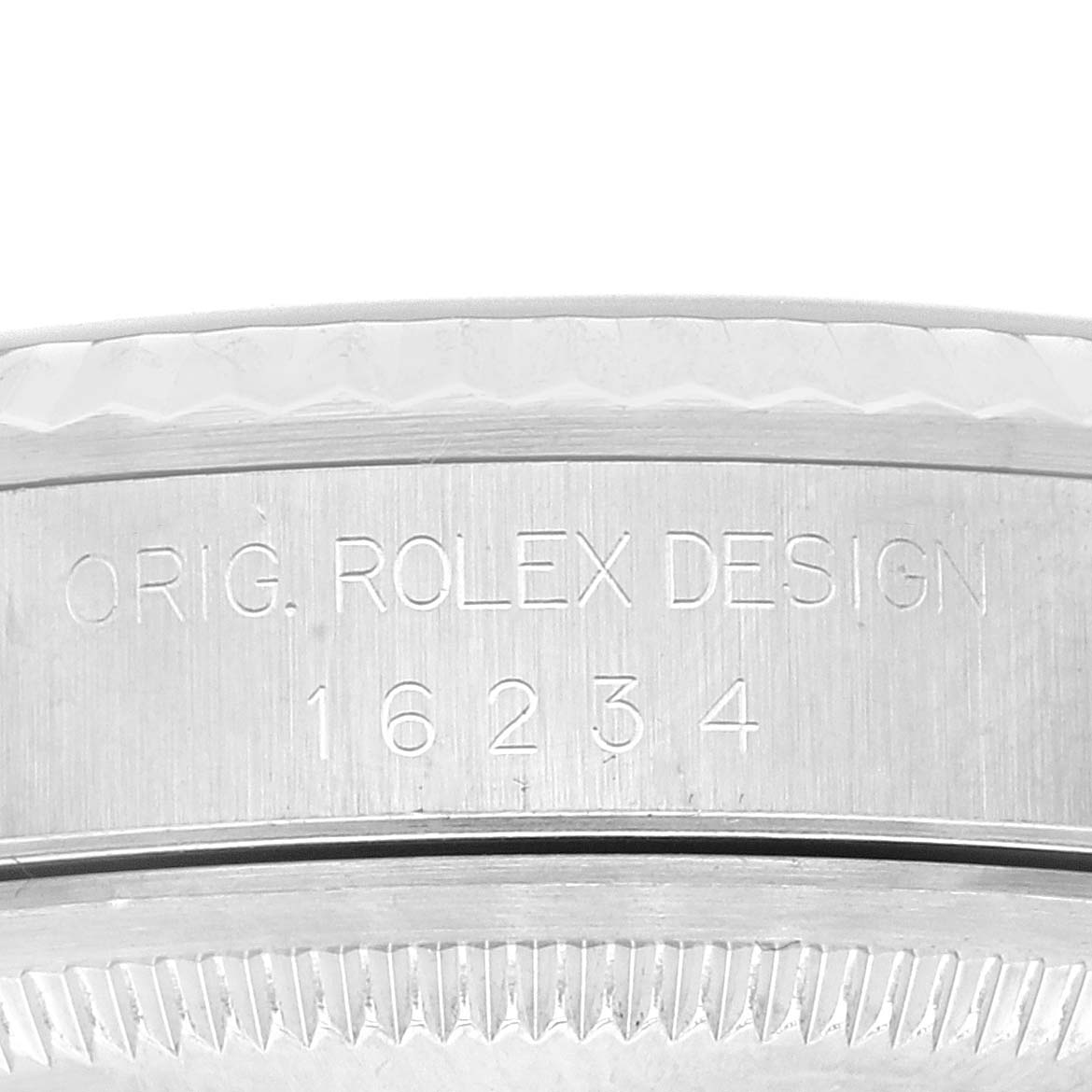 This image shows an engraved part of the bezel and case of the Rolex Datejust 16234 Men's Stainless Steel Blue Dial 16234 Men's Stainless Steel Blue Dial watch, displaying the model number 16234 and "ORIG. ROLEX DESIGN".