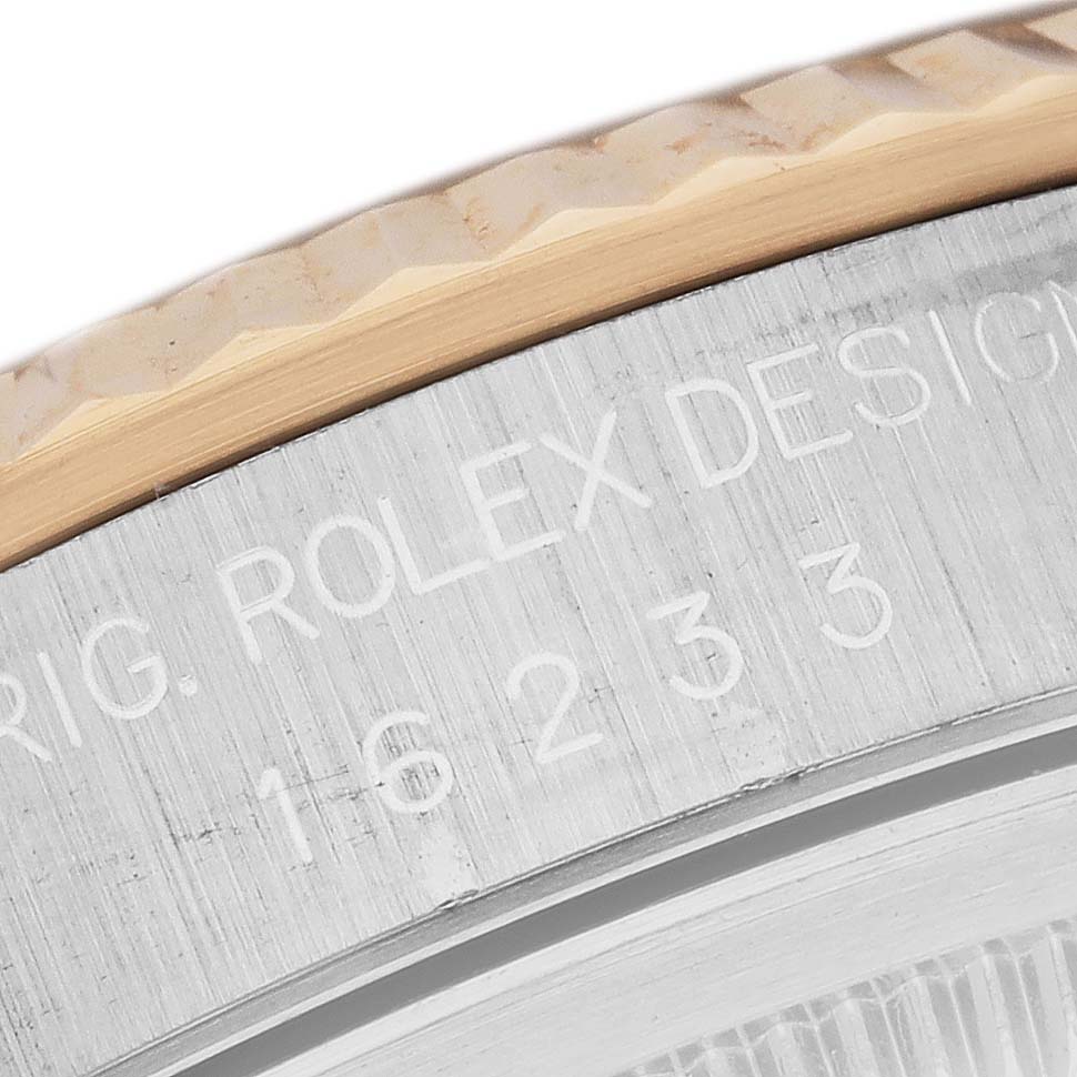 This is a close-up view of the bezel and the engraved side of the case of a Rolex Datejust 16233 Men's Stainless Steel Black Dial 16233 Men's Stainless Steel Black Dial watch.