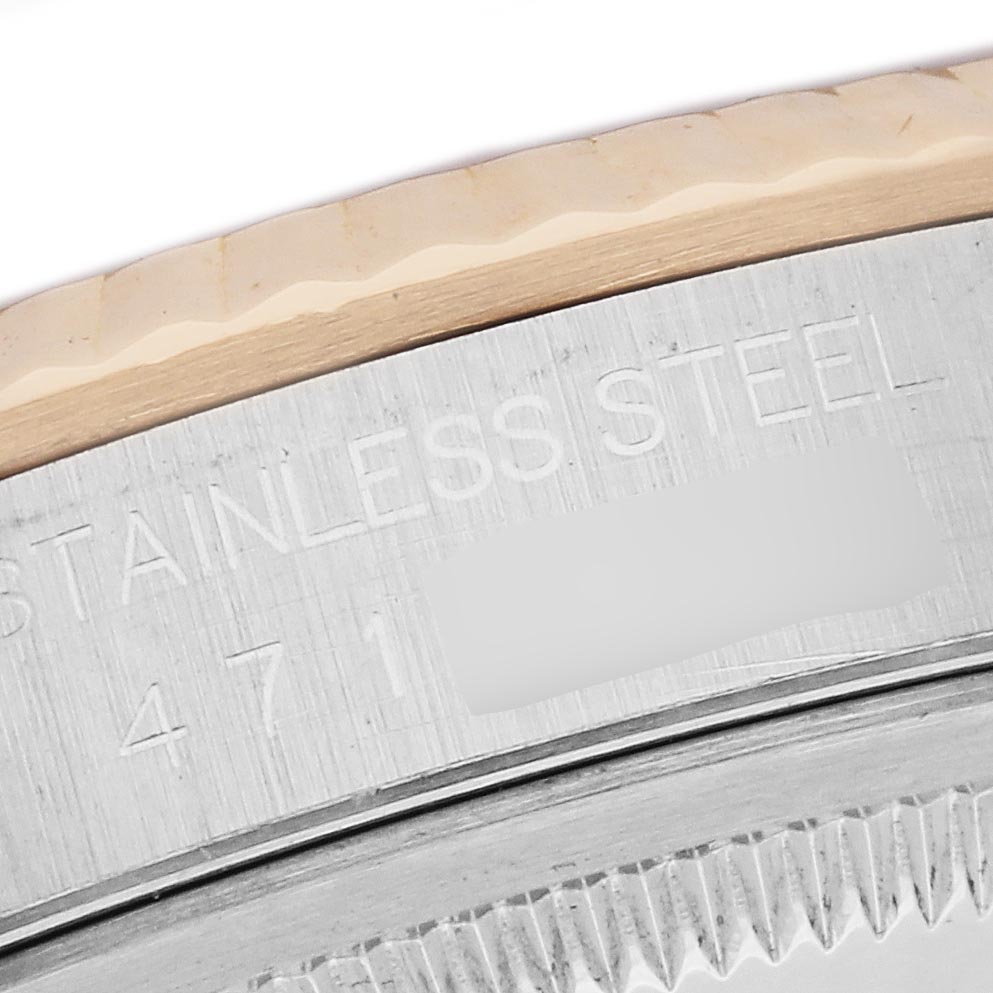 The image shows a close-up of the stainless steel case and fluted bezel of the Rolex Datejust 16233 Men's Steel and Gold (two tone) Champagne Dial 16233 Men's Steel and Gold (two tone) Champagne Dial.