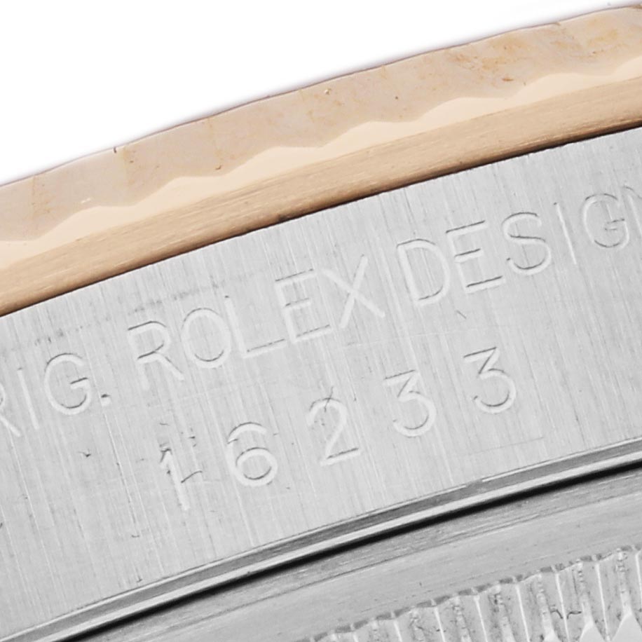 The image shows a close-up of the engraved edge on a Rolex Datejust 16233 Men's Steel and Gold (two tone) Champagne Dial 16233 Men's Steel and Gold (two tone) Champagne Dial watch, featuring the model number "16233."