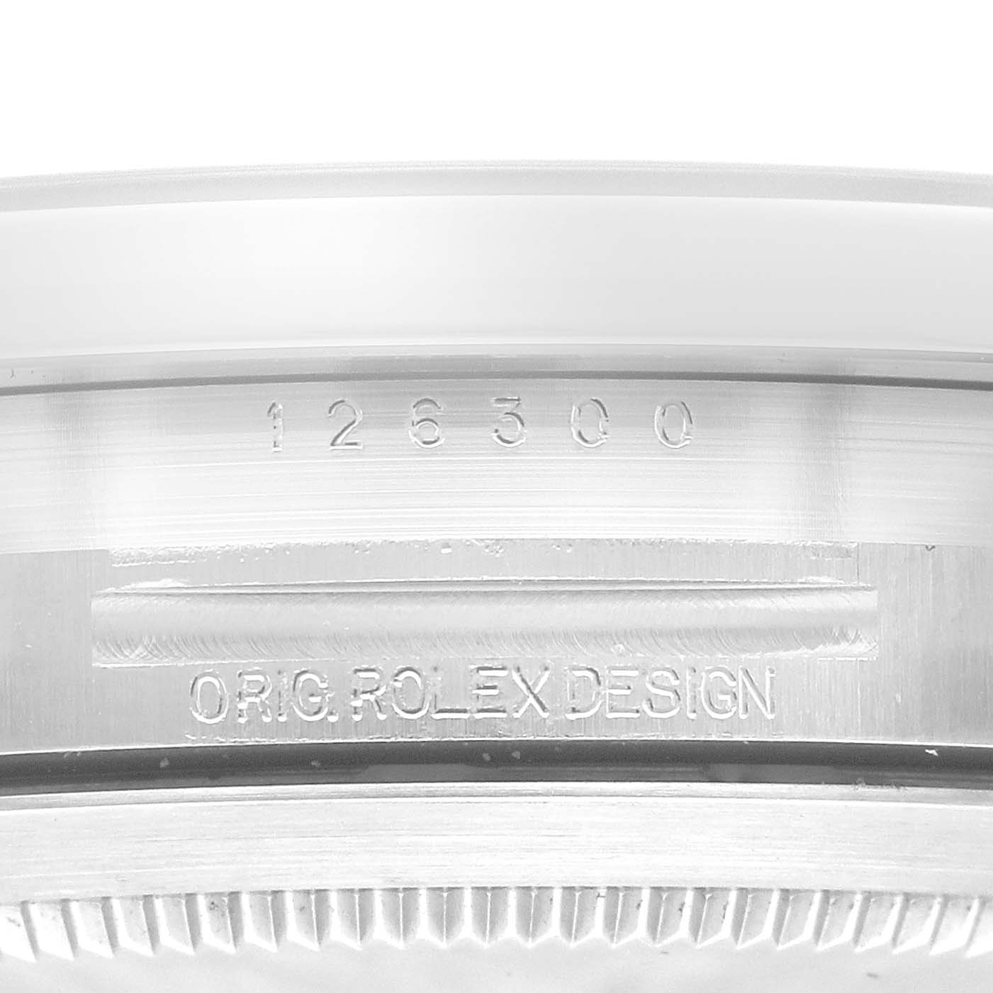 The image shows a close-up of the side of a Rolex Datejust 41 126300 Men
s Stainless Steel Blue Dial 126300 Men
s Stainless Steel Blue Dial, displaying the engraved model number and "ORIG. ROLEX DESIGN" text.