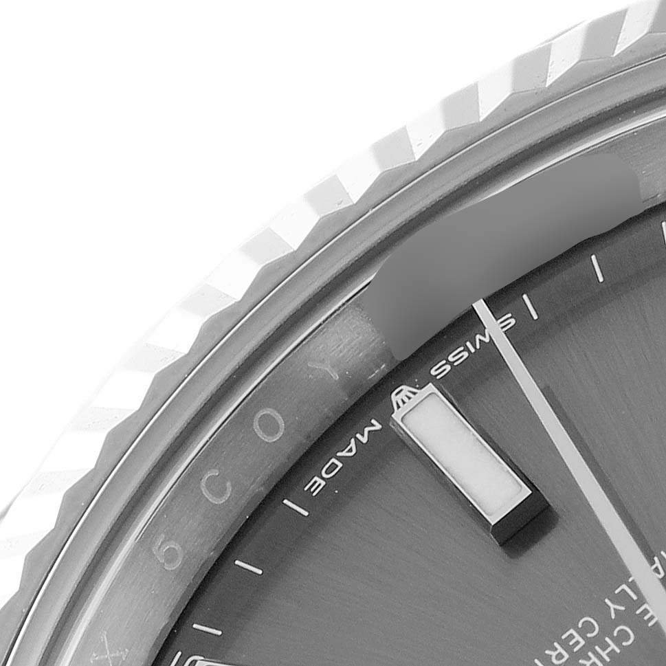 This image shows a close-up of the Rolex Datejust 41 126334 Men
s Stainless Steel Grey Dial 126334 Men
s Stainless Steel Grey Dial
s bezel, part of the dial, and logo inscription.