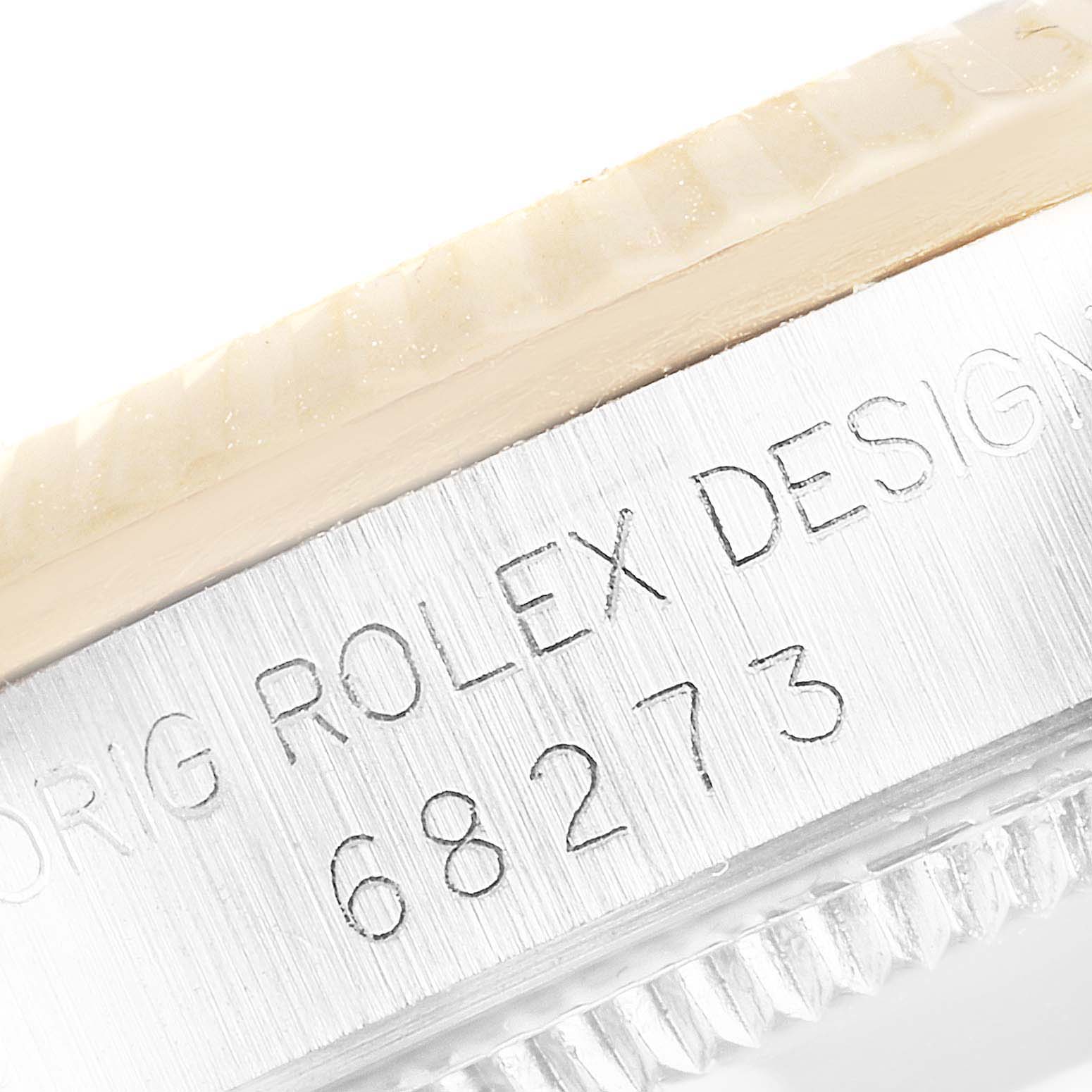 This image shows a close-up of the case engraving, bezel, and part of the crystal of a Rolex Mid-Size 68273 Women
s Steel and Gold (two tone) Black Dial 68273 Women
s Steel and Gold (two tone) Black Dial model, including model number 68273.