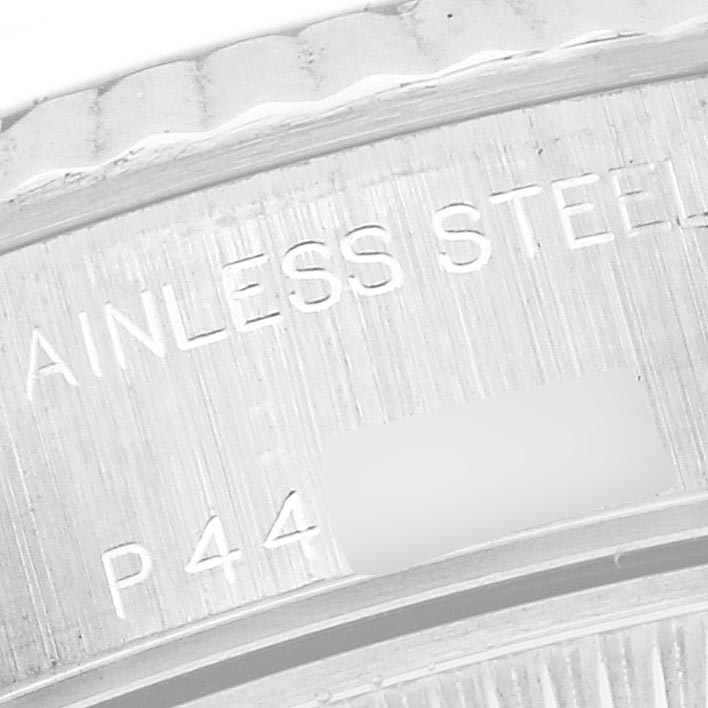 The image shows a close-up of the side of the Rolex Datejust 79174 Women's Stainless Steel Mother of Pearl Dial 79174 Women's Stainless Steel Mother of Pearl Dial watch, highlighting the etched stainless steel texture and markings.