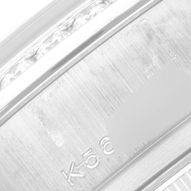 This close-up image shows a portion of the engraved metal band of the Rolex President 179159 Women's White Gold Silver Dial 179159 Women's White Gold Silver Dial model watch.
