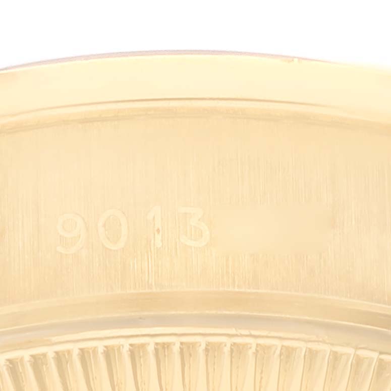 This image shows a close-up of the serial number and part of the case back rim of a Rolex President 69138 Women's Yellow Gold Black Dial 69138 Women's Yellow Gold Black Dial model watch.