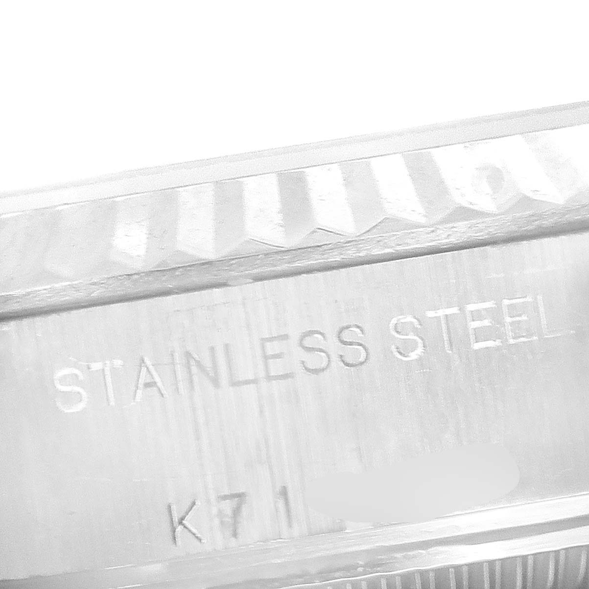 This is a close-up image showing the engraved side of a stainless steel Rolex Datejust 79174 Women's Stainless Steel White Dial 79174 Women's Stainless Steel White Dial watch.