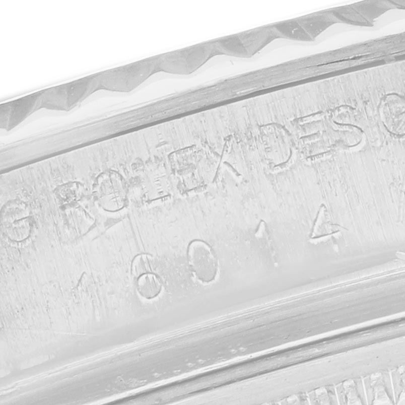 The image shows a close-up of the engraved edge of a Rolex Datejust 16014 Men's Stainless Steel Silver Dial 16014 Men's Stainless Steel Silver Dial watch bezel.