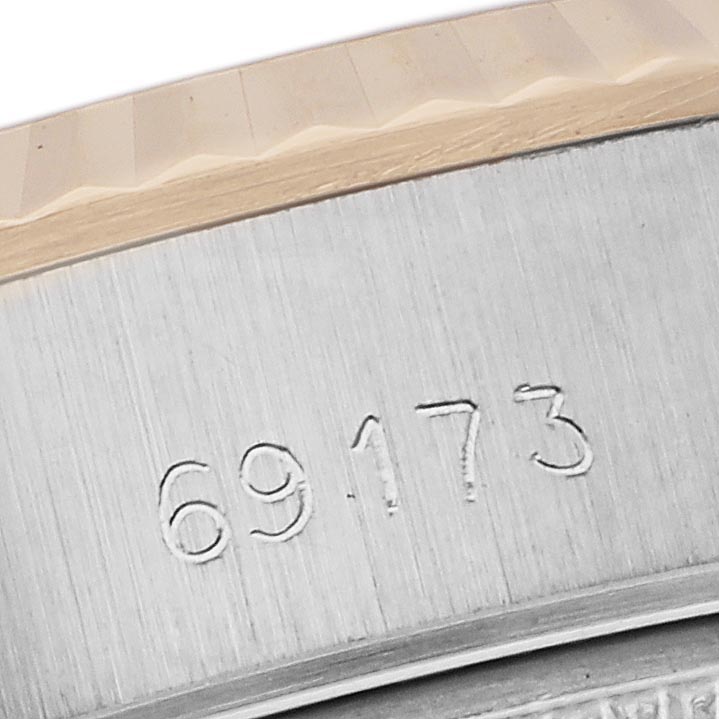 The image shows a close-up of the side of a Rolex Datejust 69173 Women's Steel and Gold (two tone) Champagne Dial 69173 Women's Steel and Gold (two tone) Champagne Dial, highlighting the case edge and engraved serial number.