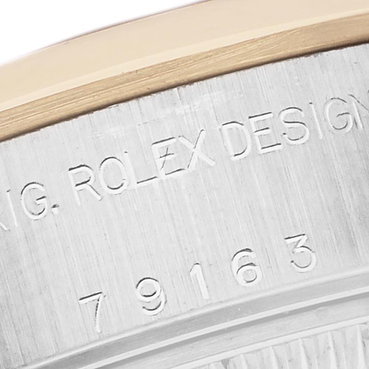 The image shows a close-up of the side of the Rolex Datejust 79163 Women's Steel and Gold (two tone) Grey Dial 79163 Women's Steel and Gold (two tone) Grey Dial, highlighting the engraved design and part of the model number.