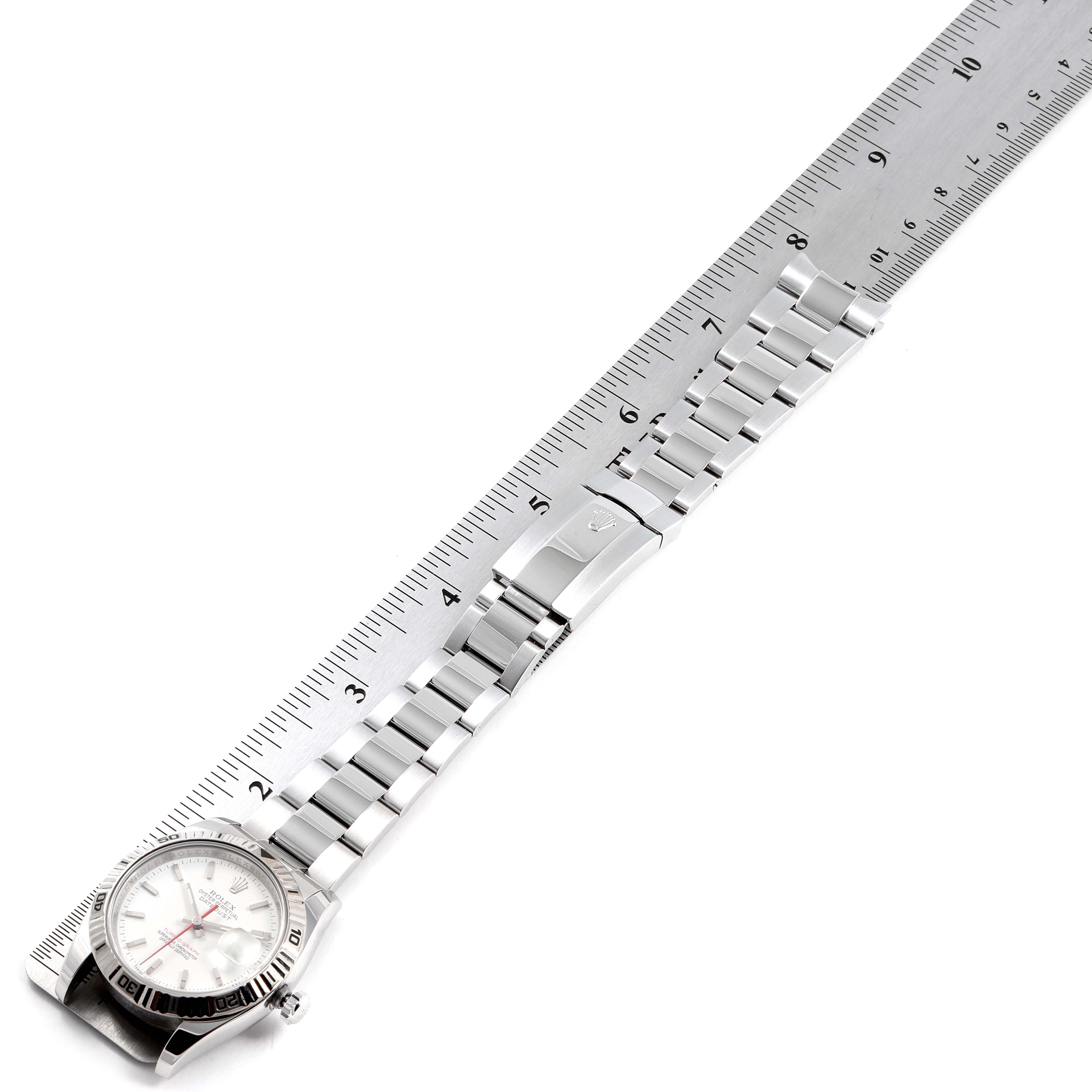 The image shows a top-down view of the Rolex Turn-o-Graph 116264 Men
s Stainless Steel White Dial 116264 Men
s Stainless Steel White Dial watch fully extended next to a ruler.