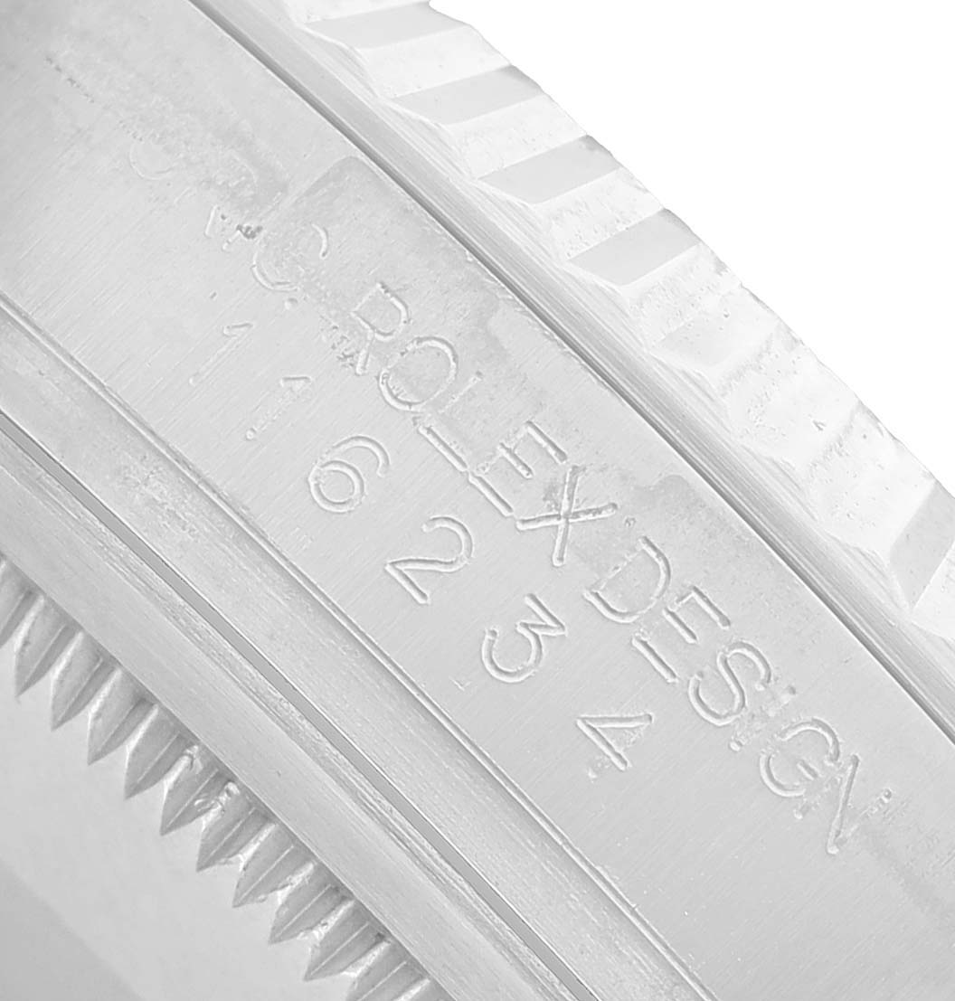 The image shows a close-up of the side engraving on the bezel of a Rolex Datejust 116234 Men's Stainless Steel White Dial watch.