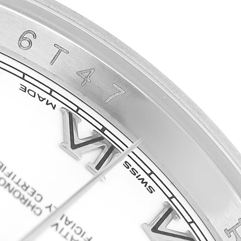 The image shows a close-up of the Rolex Datejust 116234 Men's Stainless Steel White Dial dial and bezel, highlighting the Roman numeral "VI" and surrounding engravings.