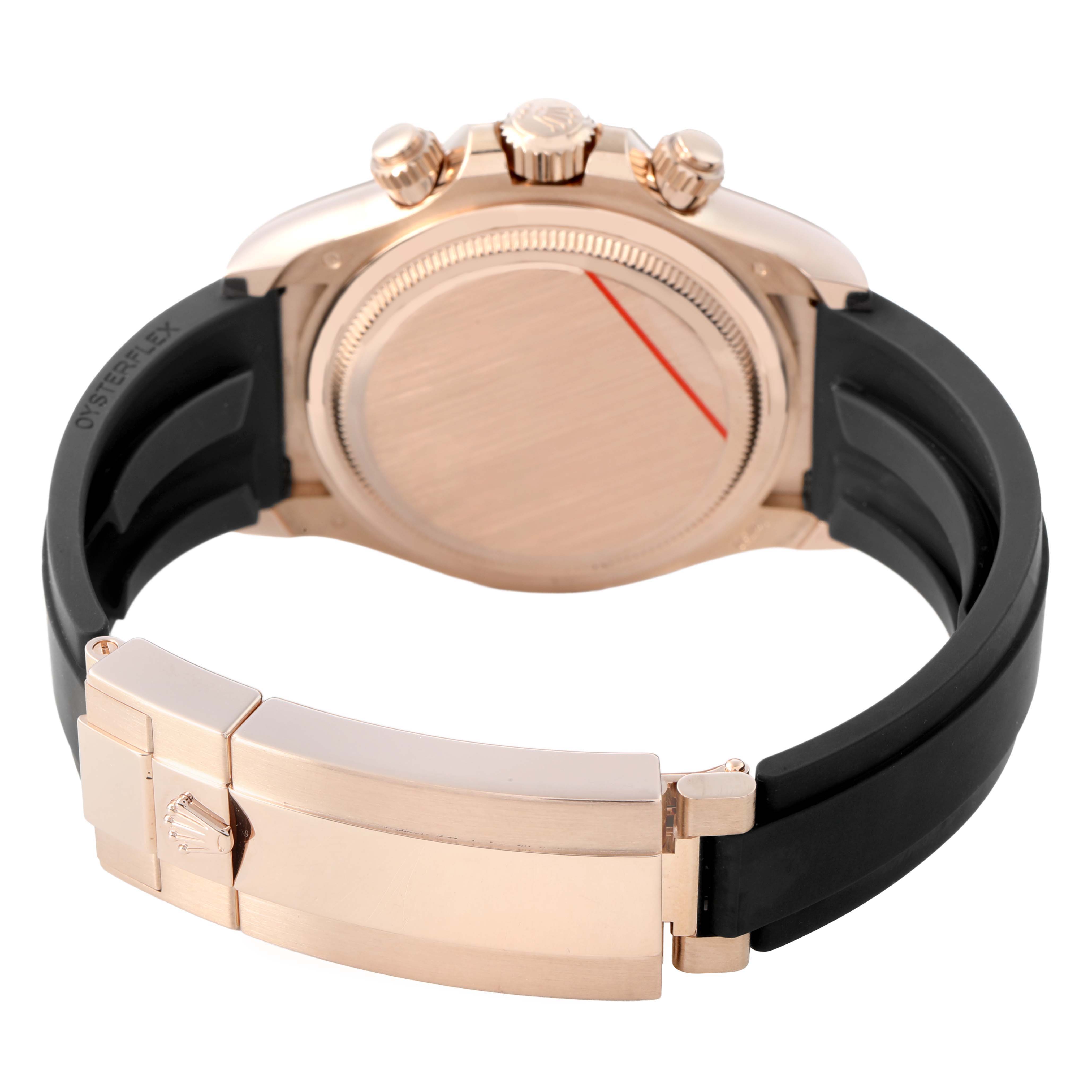 The image shows a rear angle of the Rolex Daytona 126515LN Men's Rose Gold Black Dial watch, highlighting the case back, crown, pushers, clasp, and rubber strap.