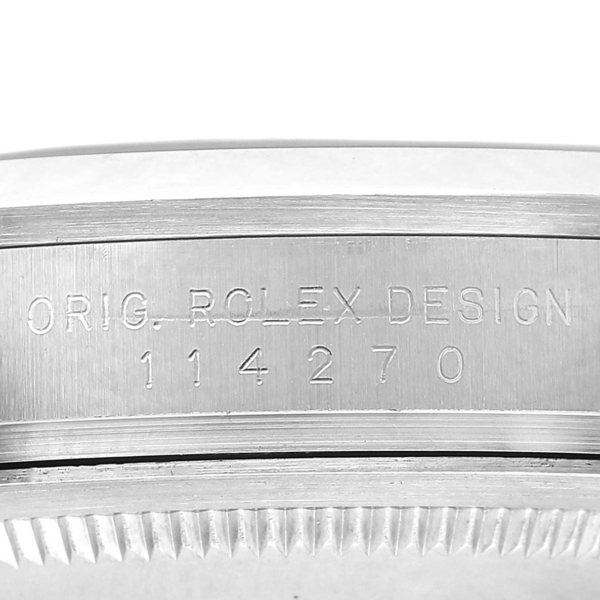 The image shows a close-up of the case side engraving on a Rolex Explorer 114270 Men's Stainless Steel Black Dial, displaying the model number and "ORIG. ROLEX DESIGN."
