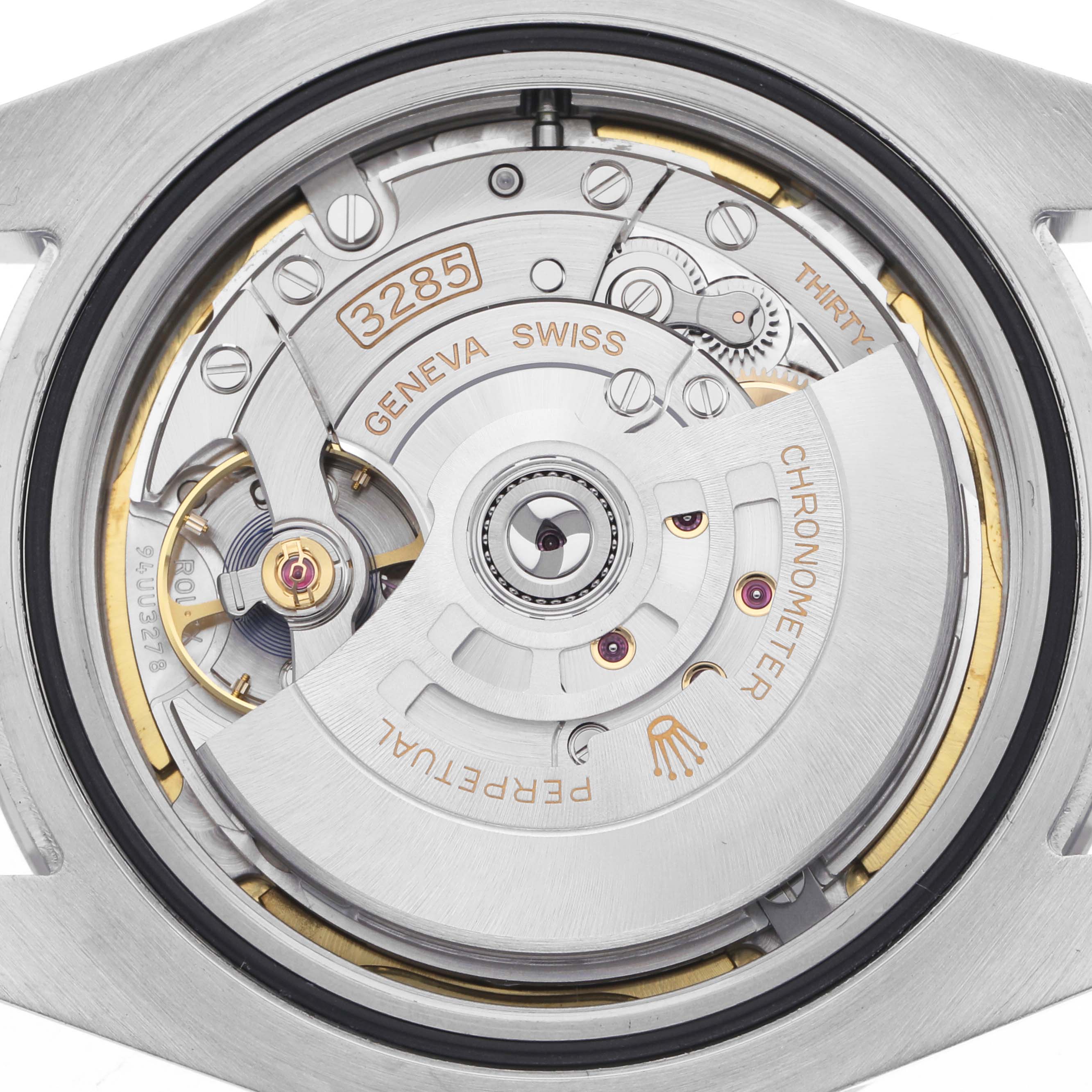 The image shows a close-up of the Rolex GMT-Master 226570 Men's Stainless Steel Black Dial 226570 Men's Stainless Steel Black Dial's movement, highlighting the caliber 3285 and intricate mechanical parts.