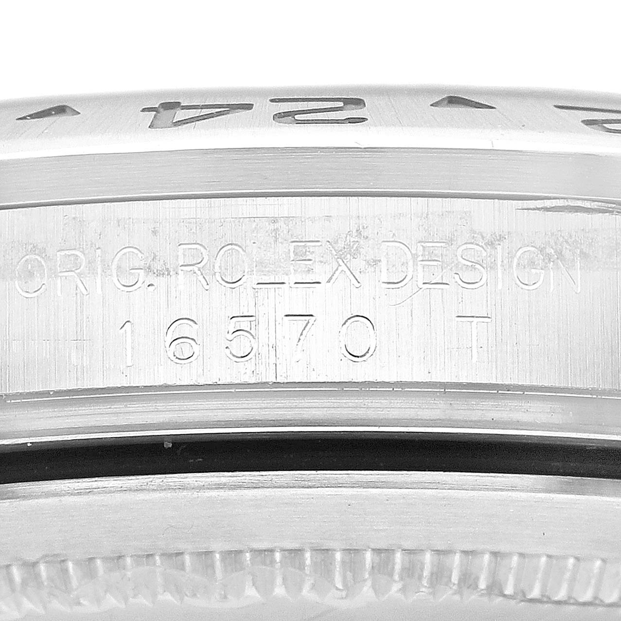 The image shows a close-up of the case side of a Rolex Explorer 16570 Men's Stainless Steel Black Dial 16570 Men's Stainless Steel Black Dial model, focusing on the engravings and bezel.