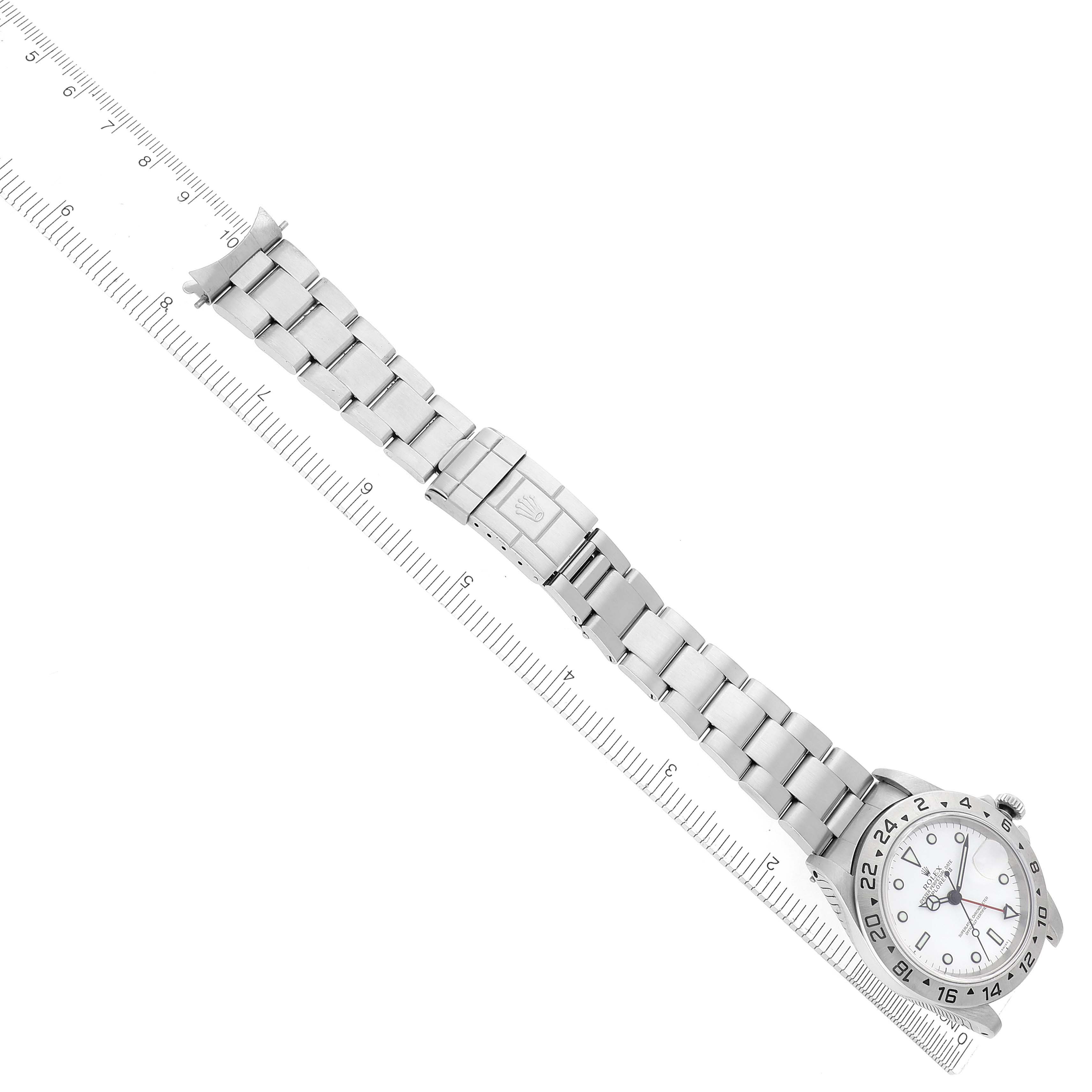 The Rolex Explorer 16570 Men's Stainless Steel White Dial 16570 Men's Stainless Steel White Dial watch is displayed flat, showing the full bracelet and clasp alongside a ruler for scale.