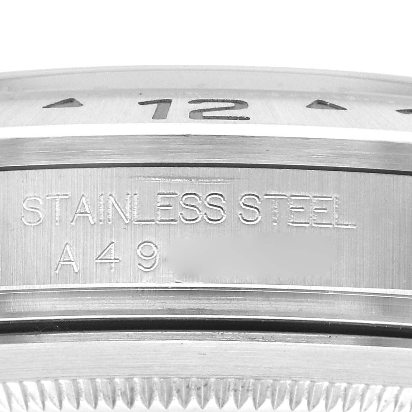 The image shows a close-up of the side and bezel of a Rolex Explorer 16570 Men's Stainless Steel White Dial 16570 Men's Stainless Steel White Dial, highlighting the "Stainless Steel" engraving.