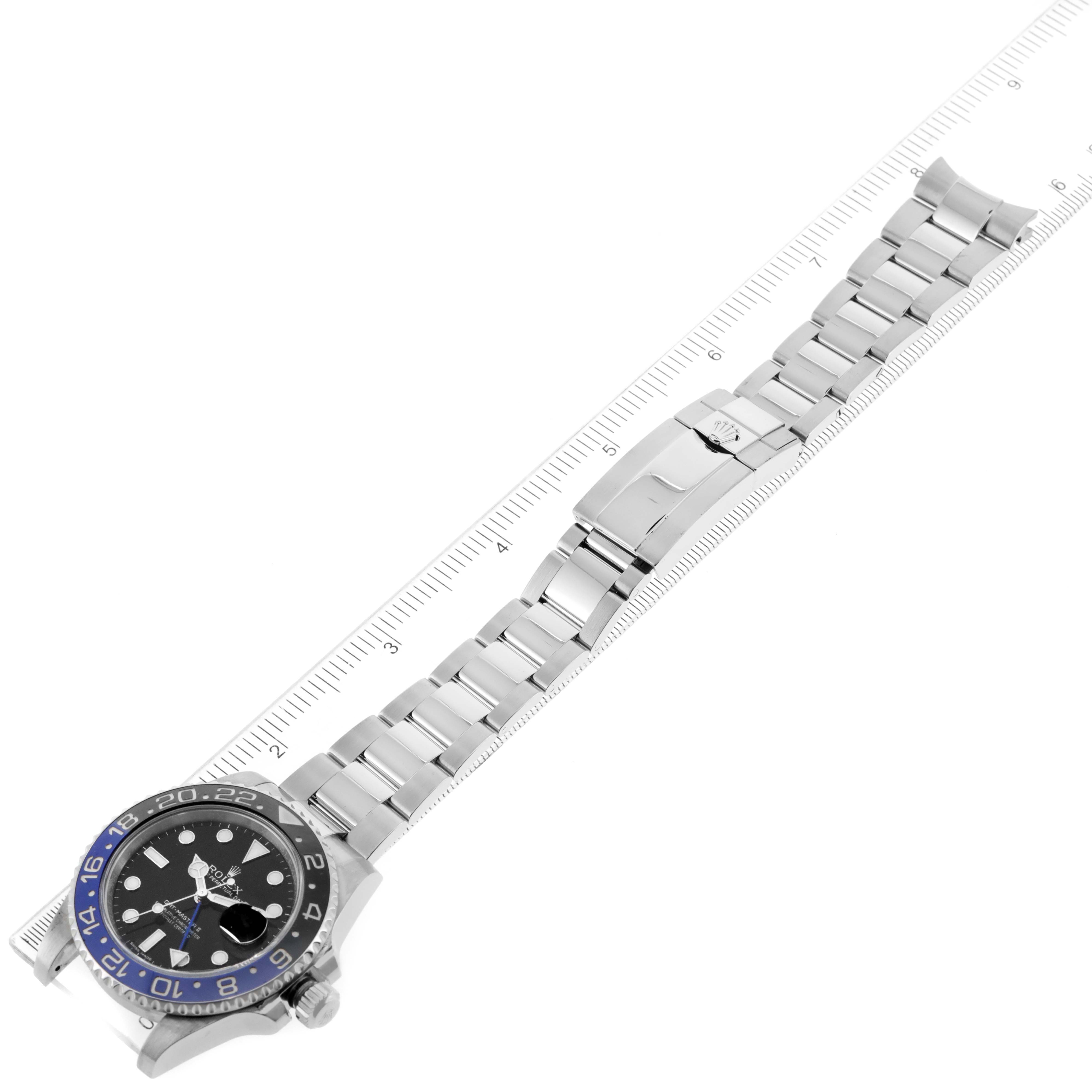 The Rolex GMT-Master 116710 Men's Stainless Steel Black Dial 116710 Men's Stainless Steel Black Dial watch is shown from an overhead angle, including the face, bezel, bracelet, and clasp, alongside a ruler for scale.