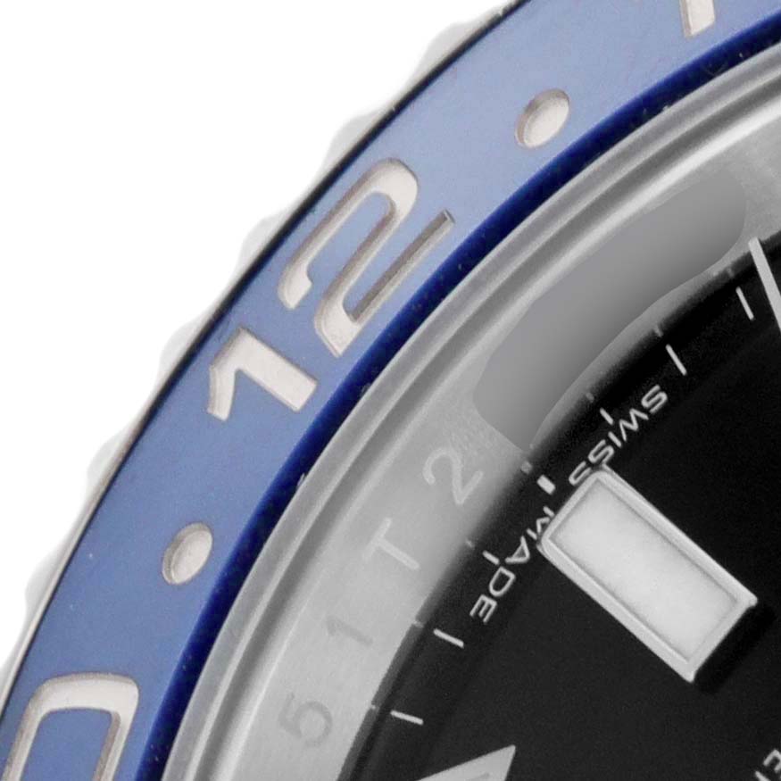 The image shows a close-up of the bezel and dial of a Rolex GMT-Master 116710 Men's Stainless Steel Black Dial 116710 Men's Stainless Steel Black Dial watch, highlighting the 12 and a portion of the "Swiss Made" text.
