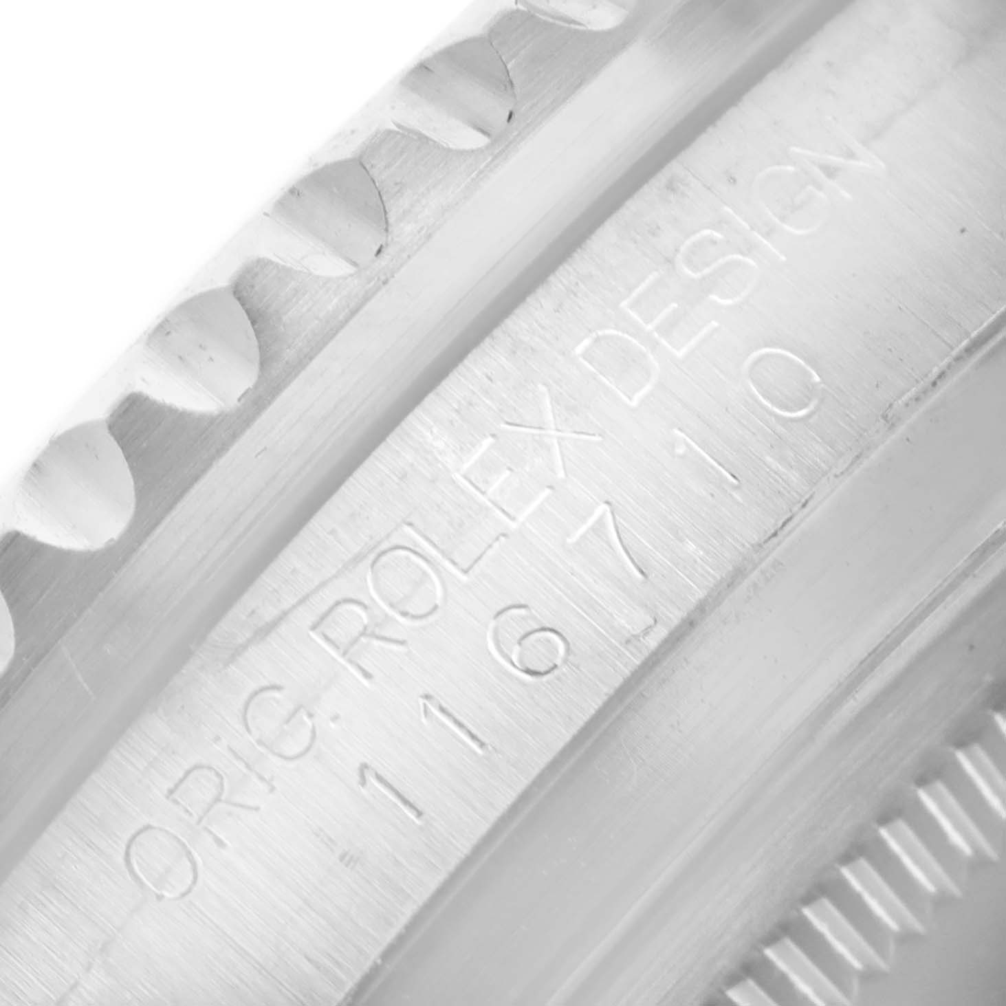 The image shows a close-up of the bezel and inner casing of a Rolex GMT-Master 116710 Men's Stainless Steel Black Dial 116710 Men's Stainless Steel Black Dial watch with engraved text.