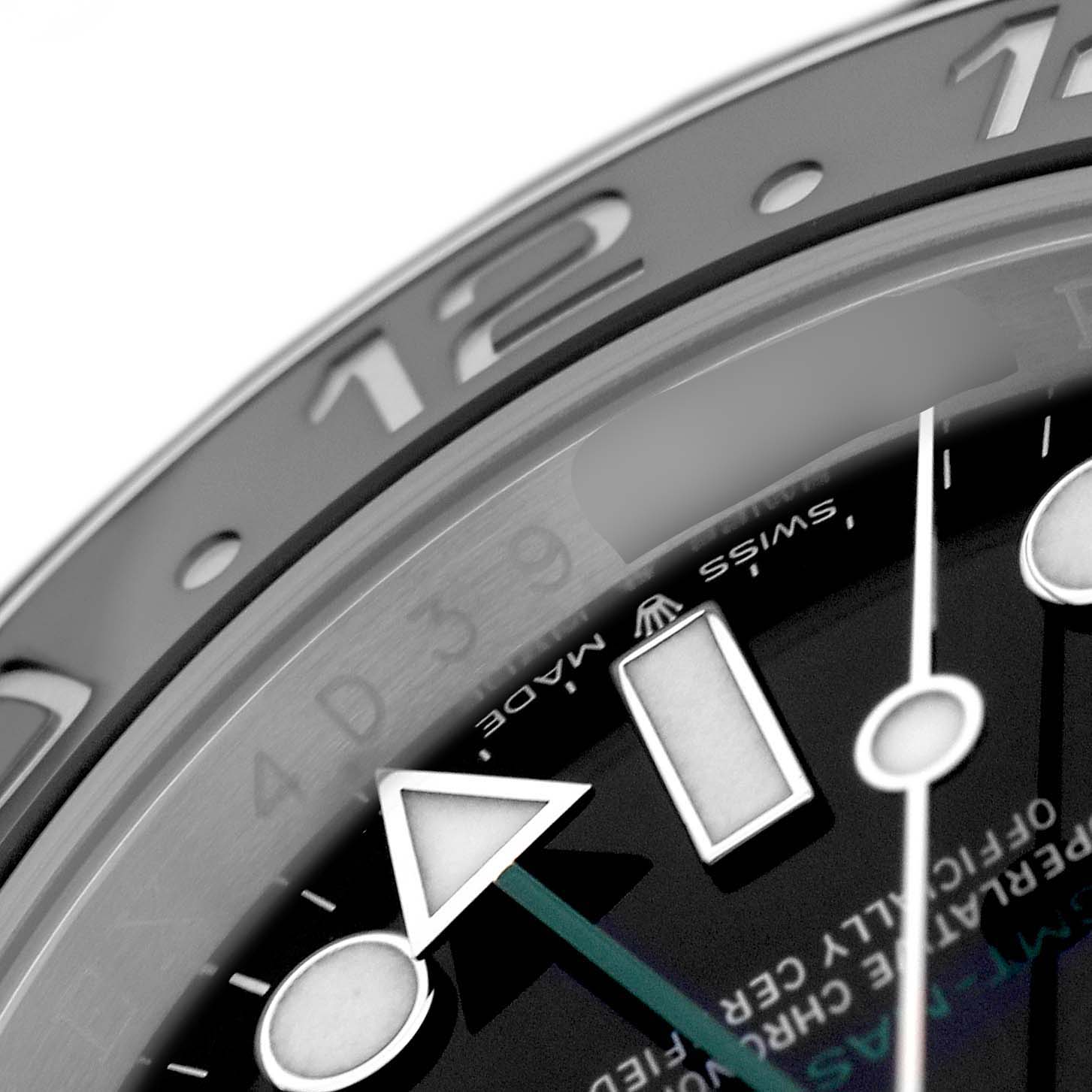 The image shows a close-up of the Rolex GMT-Master M126710GRNR-0003 Men's Stainless Steel Black Dial watch's bezel and dial, featuring the 12 marker and hands.