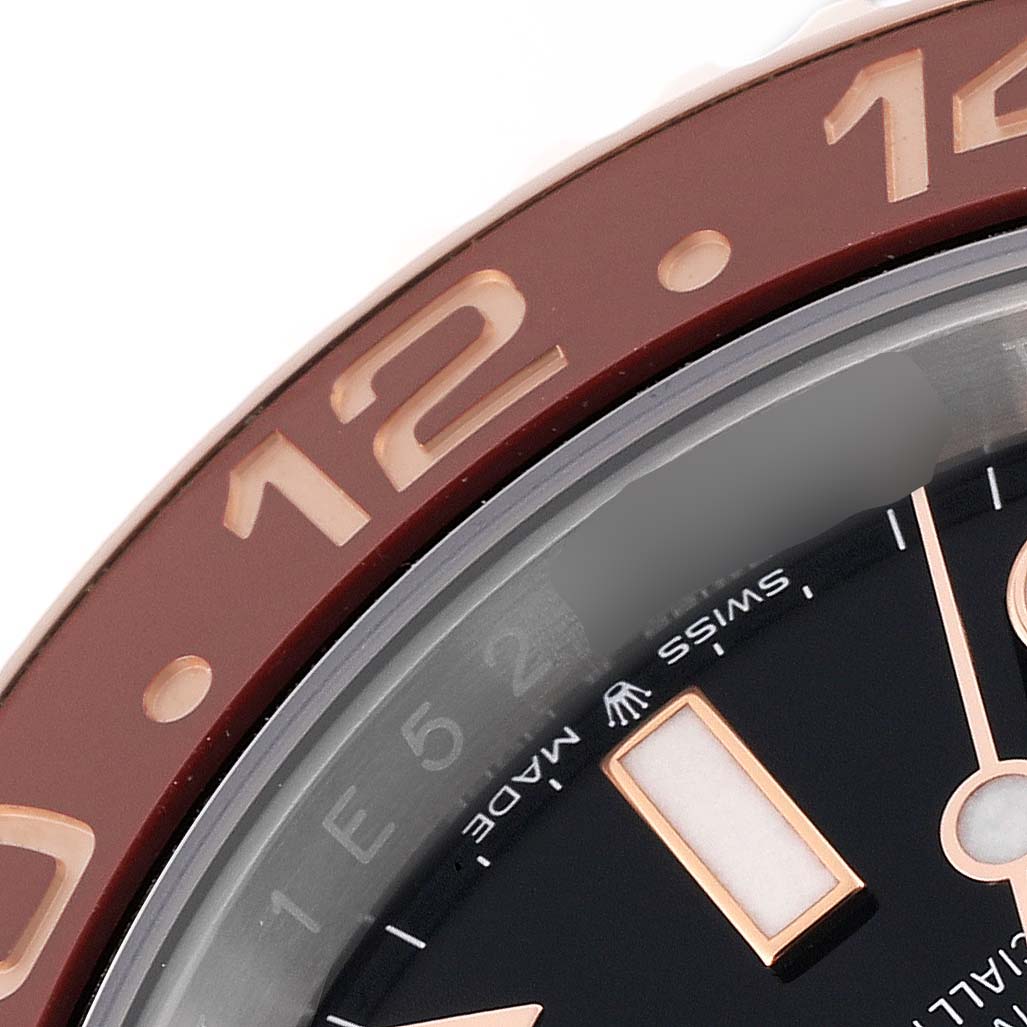 This close-up photo shows part of the bezel and dial of a Rolex GMT-Master 126711CHNR Men's Steel and Gold (two tone) Black Dial 126711CHNR Men's Steel and Gold (two tone) Black Dial watch.