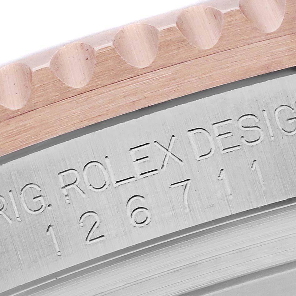 The image shows a close-up view of the bezel and the side of the case with engraved details of a Rolex GMT-Master 126711CHNR Men's Steel and Gold (two tone) Black Dial 126711CHNR Men's Steel and Gold (two tone) Black Dial watch.