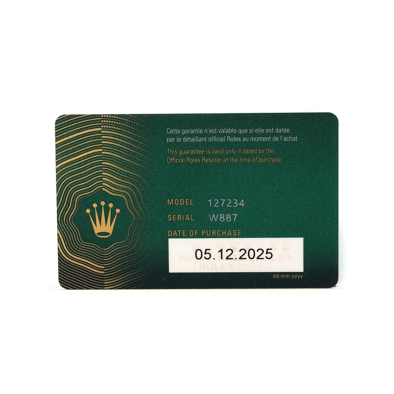 The image shows a warranty card for the Rolex Land-Dweller model, featuring the model and serial number details.