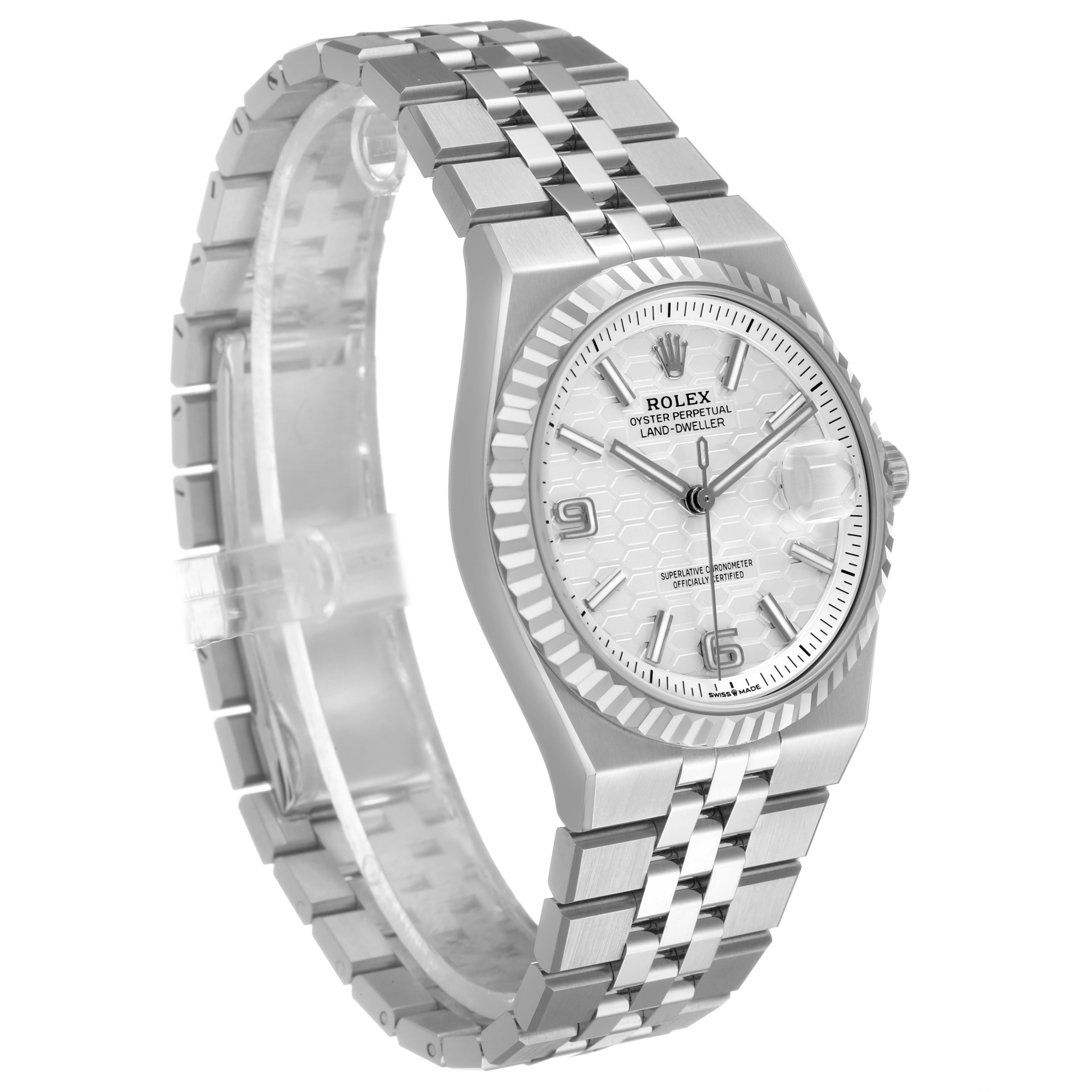 The Rolex Land-Dweller watch is shown at a three-quarter angle, displaying the face, bezel, and bracelet.