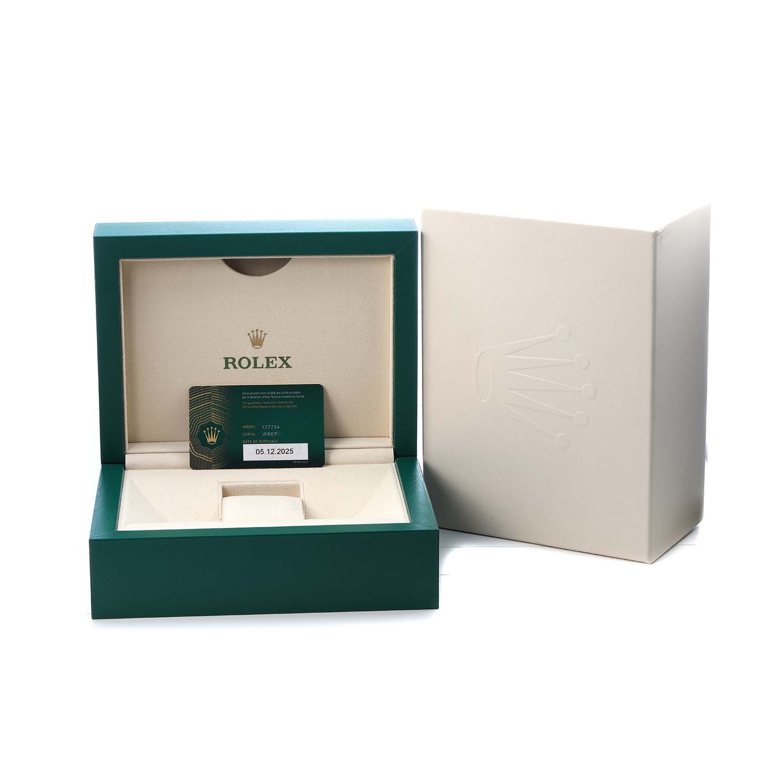 The image shows a Rolex Land-Dweller watch box with an open lid, warranty card, and outer packaging from a straight-on angle.