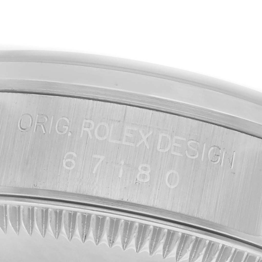 The image shows a close-up of the side engraving on the bezel of a Rolex Oyster Perpetual 67180 Women's Stainless Steel Silver Dial 67180 Women's Stainless Steel Silver Dial watch.