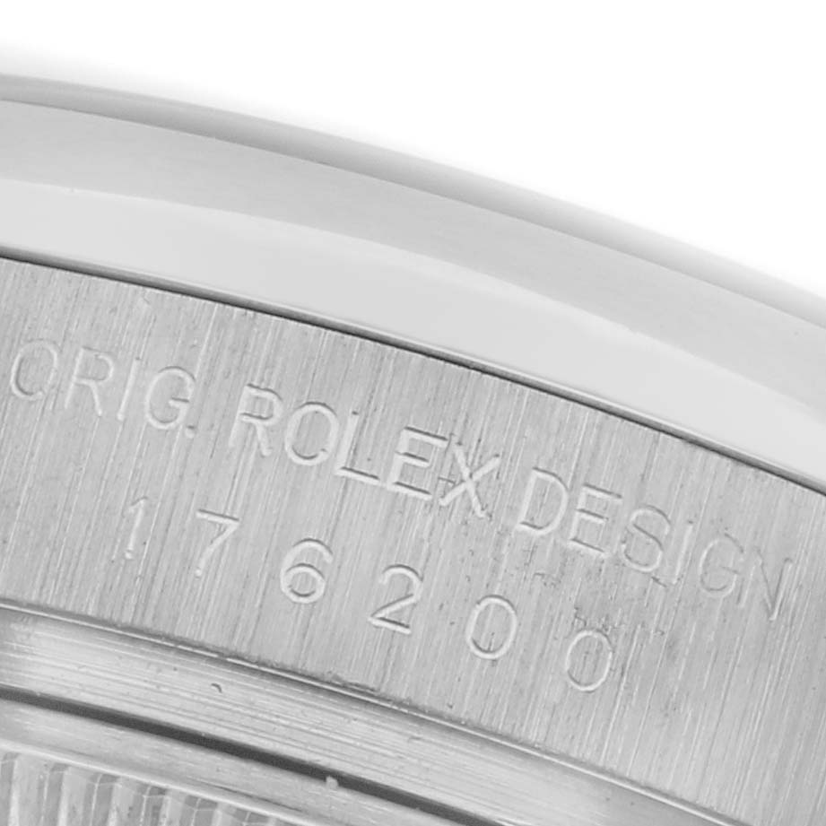 The image shows a close-up of the engraved edge of the bezel on a Rolex Oyster Perpetual 176200 Women's Stainless Steel Silver Dial 176200 Women's Stainless Steel Silver Dial watch.