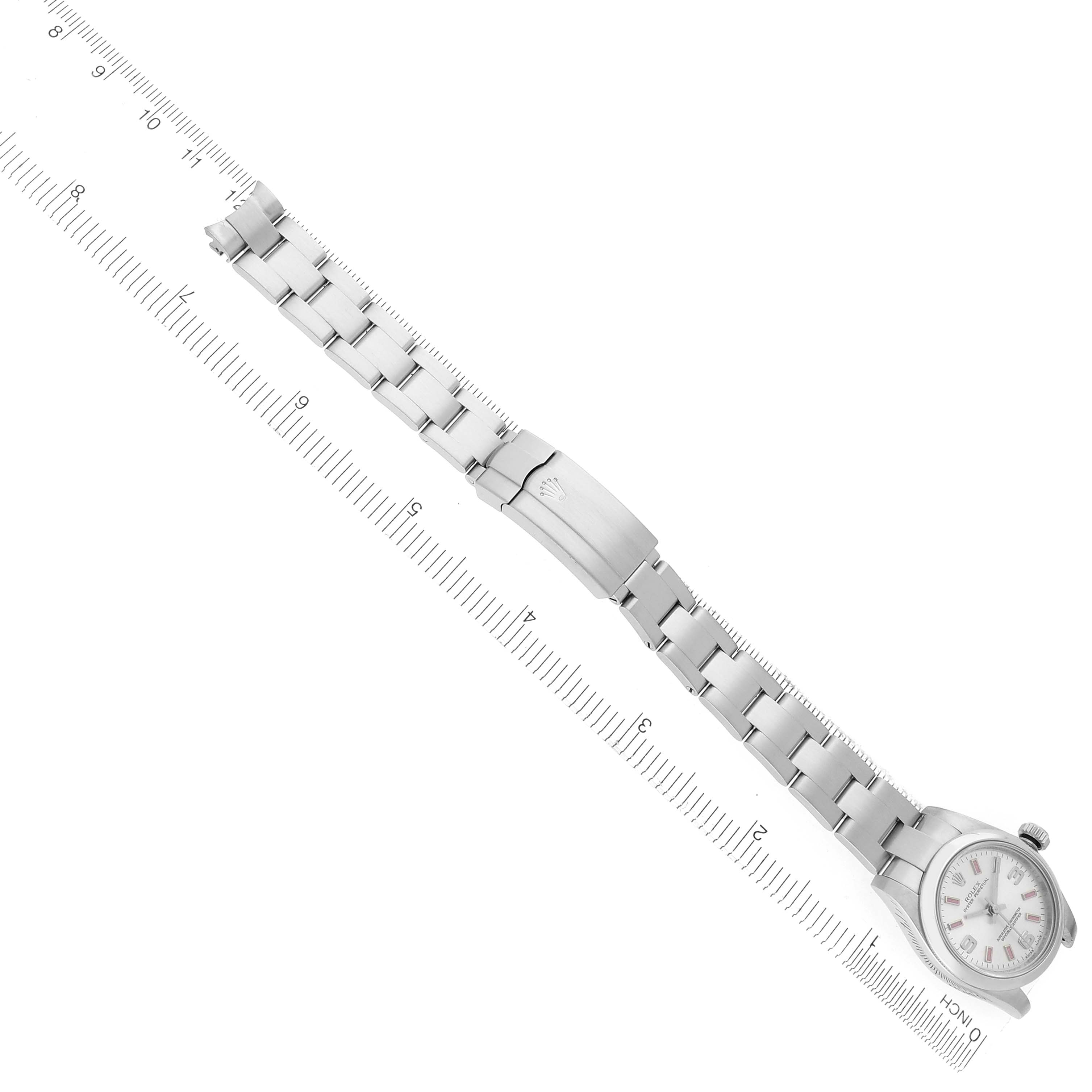 The image shows a top view of a Rolex Oyster Perpetual 176200 Women's Stainless Steel Silver Dial 176200 Women's Stainless Steel Silver Dial watch with a metal bracelet, displayed alongside a ruler for scale.